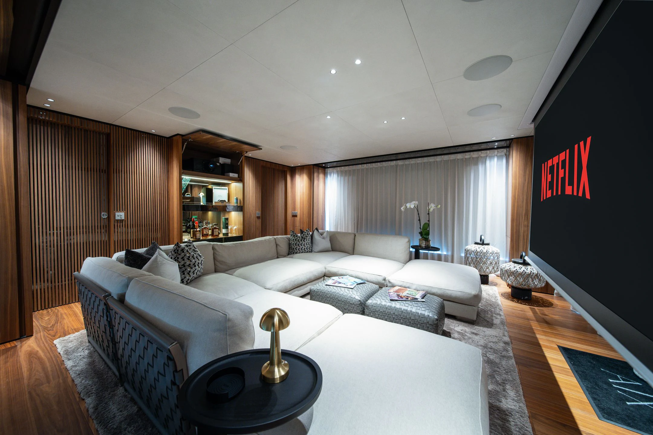 a living room with a large screen aboard AIX Yacht for Sale