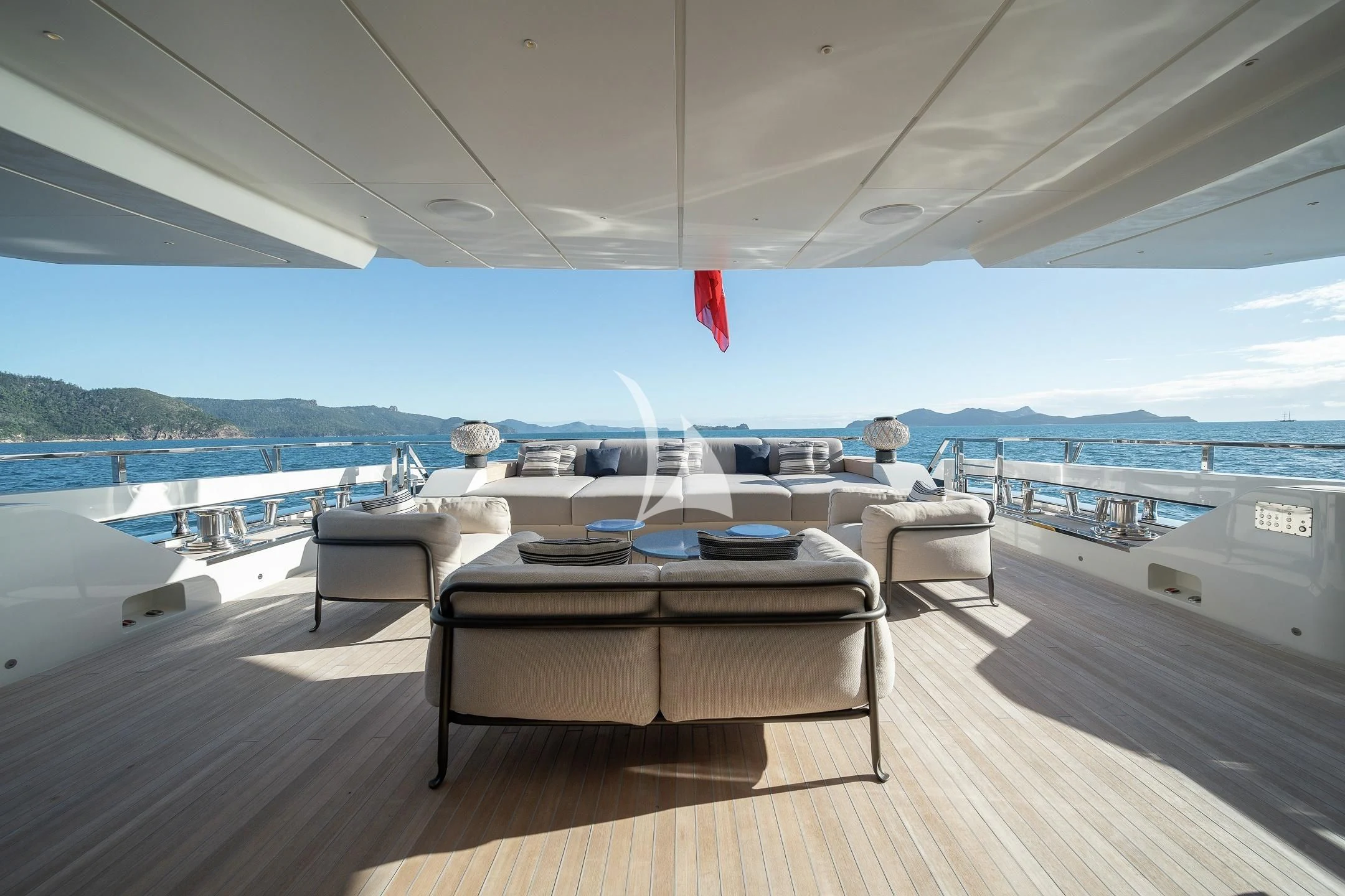a room with a bed and a table on a deck aboard AIX Yacht for Sale