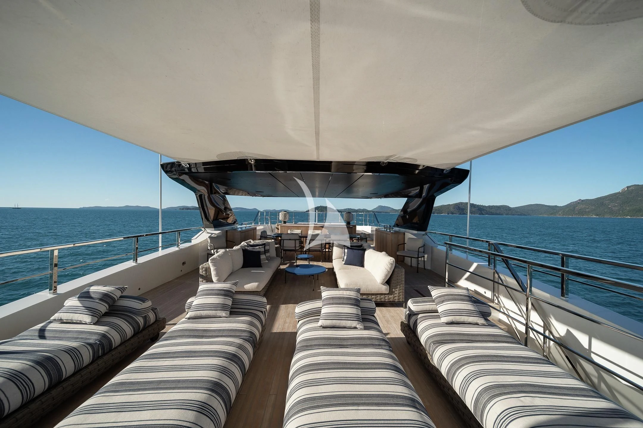 a boat with a deck and chairs on the deck aboard AIX Yacht for Sale