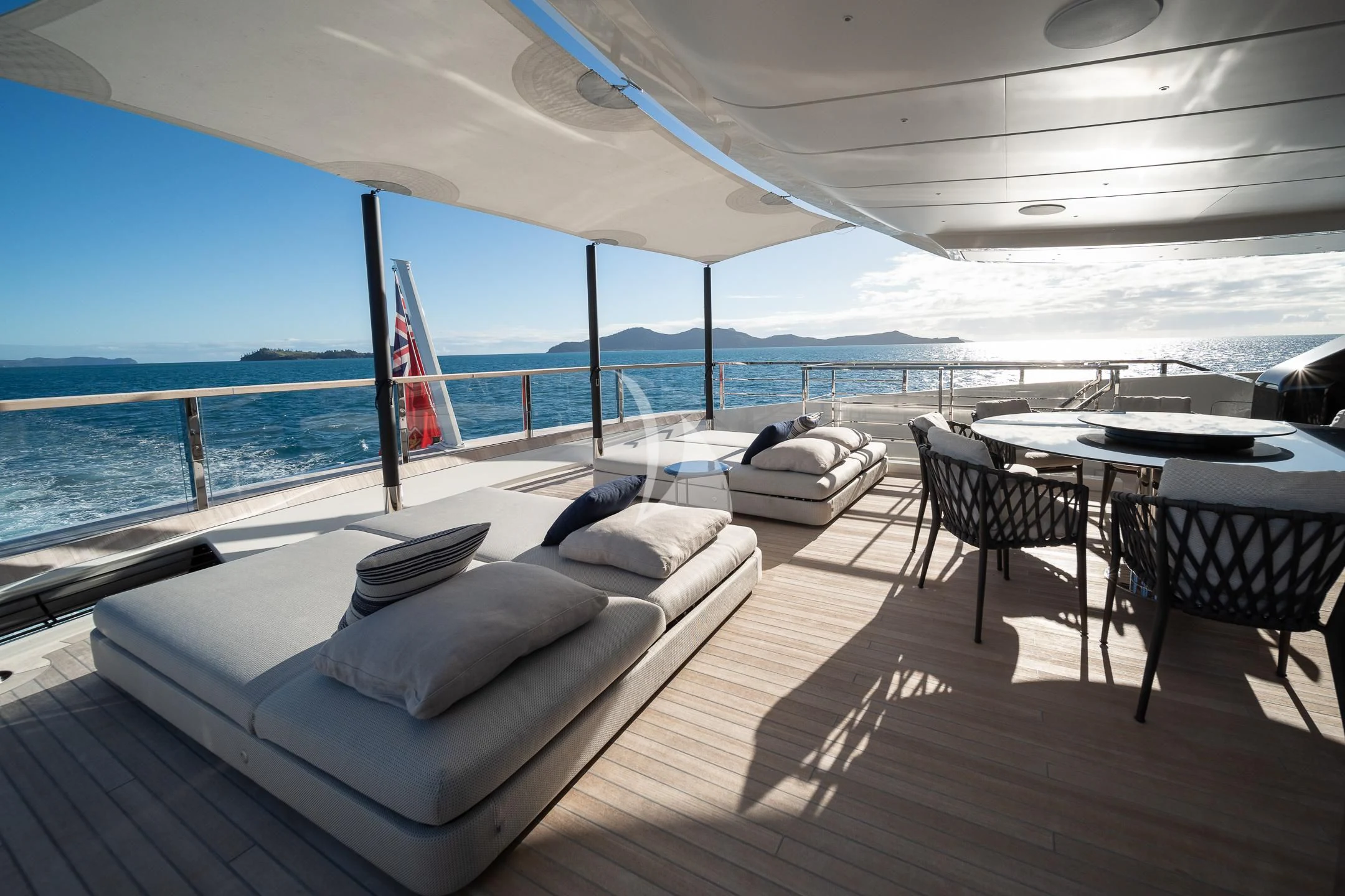 a lounge area with a large body of water and a large blue sky aboard AIX Yacht for Sale