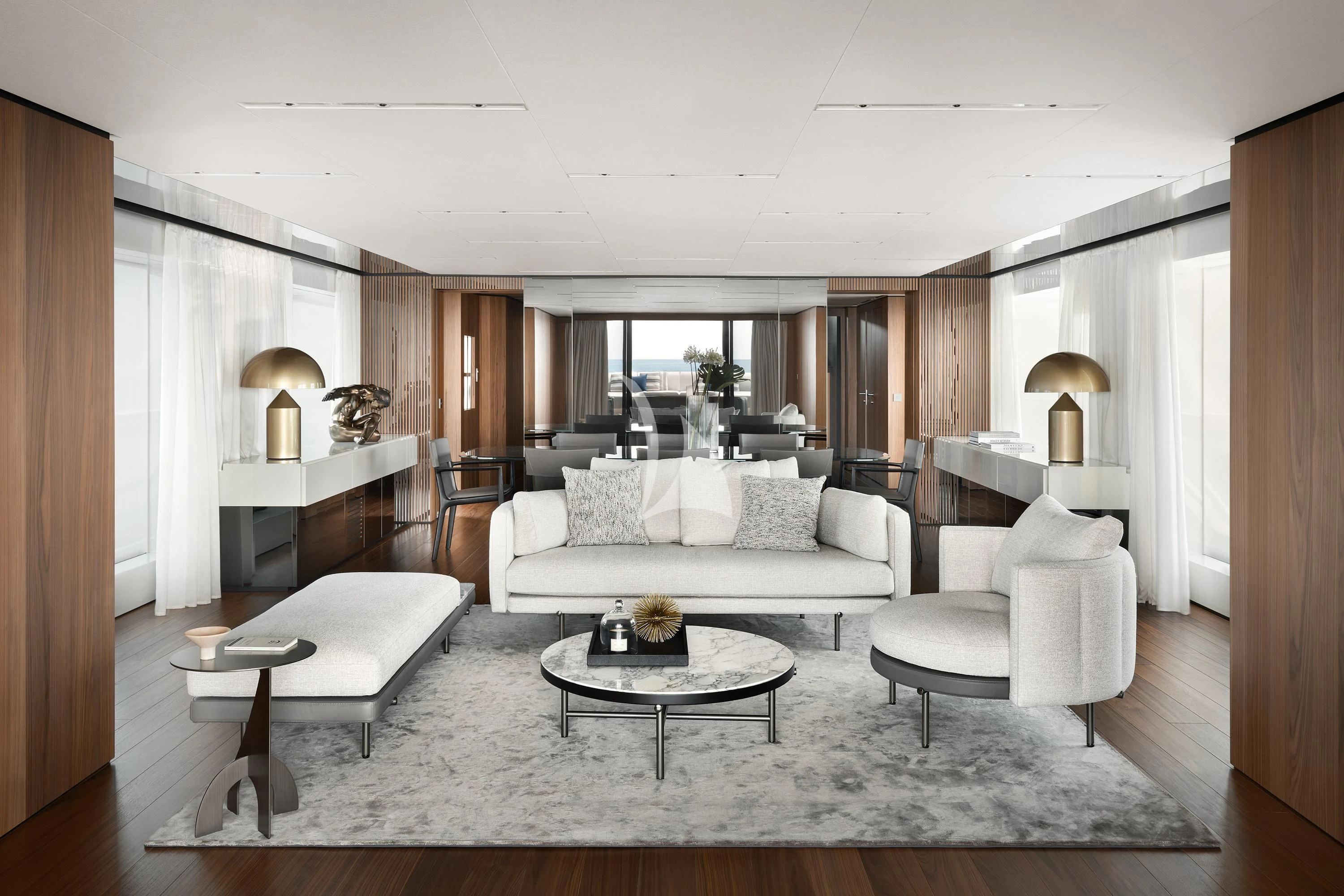 a living room with a large white couch and a large window aboard AIX Yacht for Sale