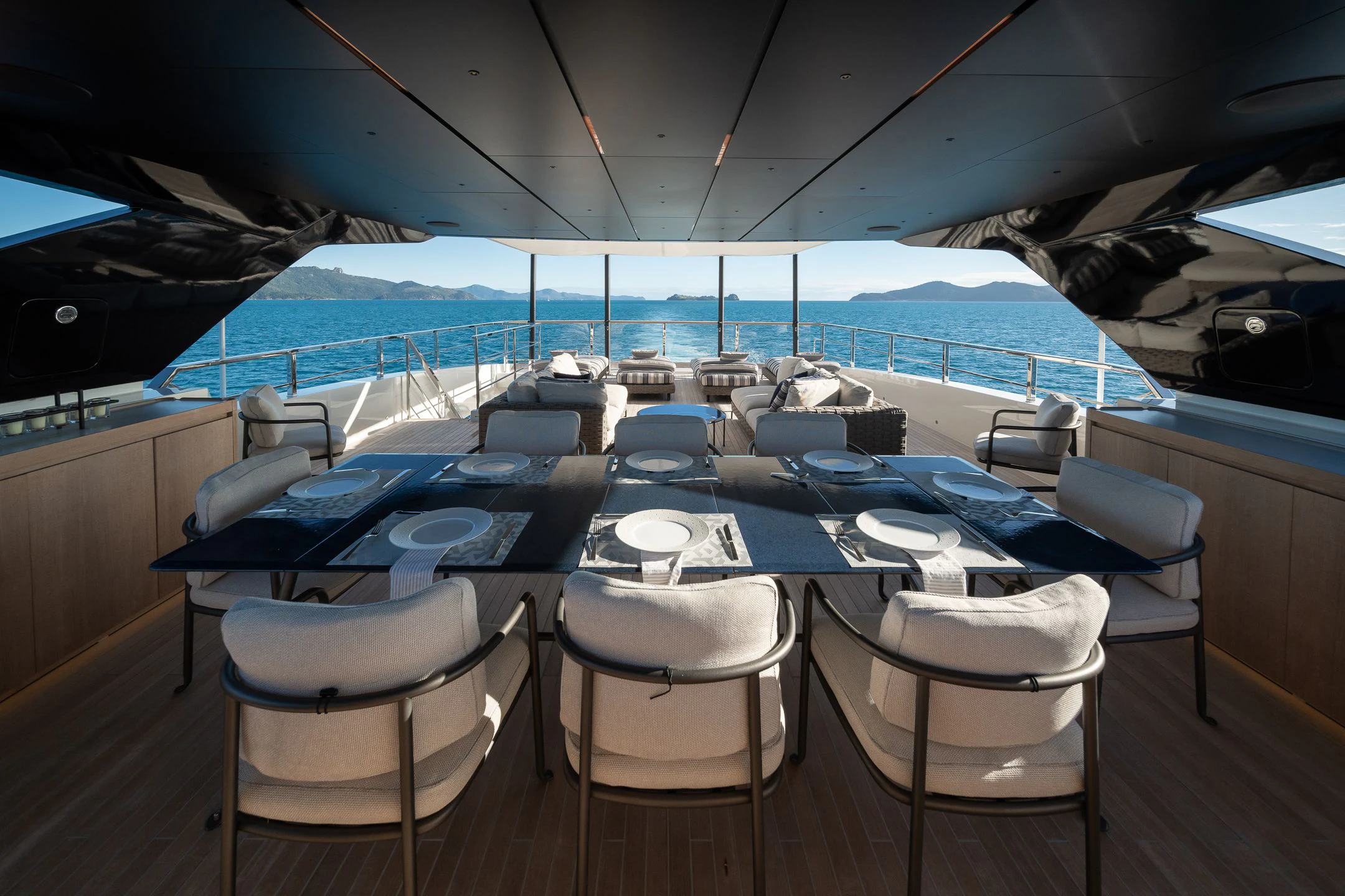 a table with chairs and umbrellas aboard AIX Yacht for Sale