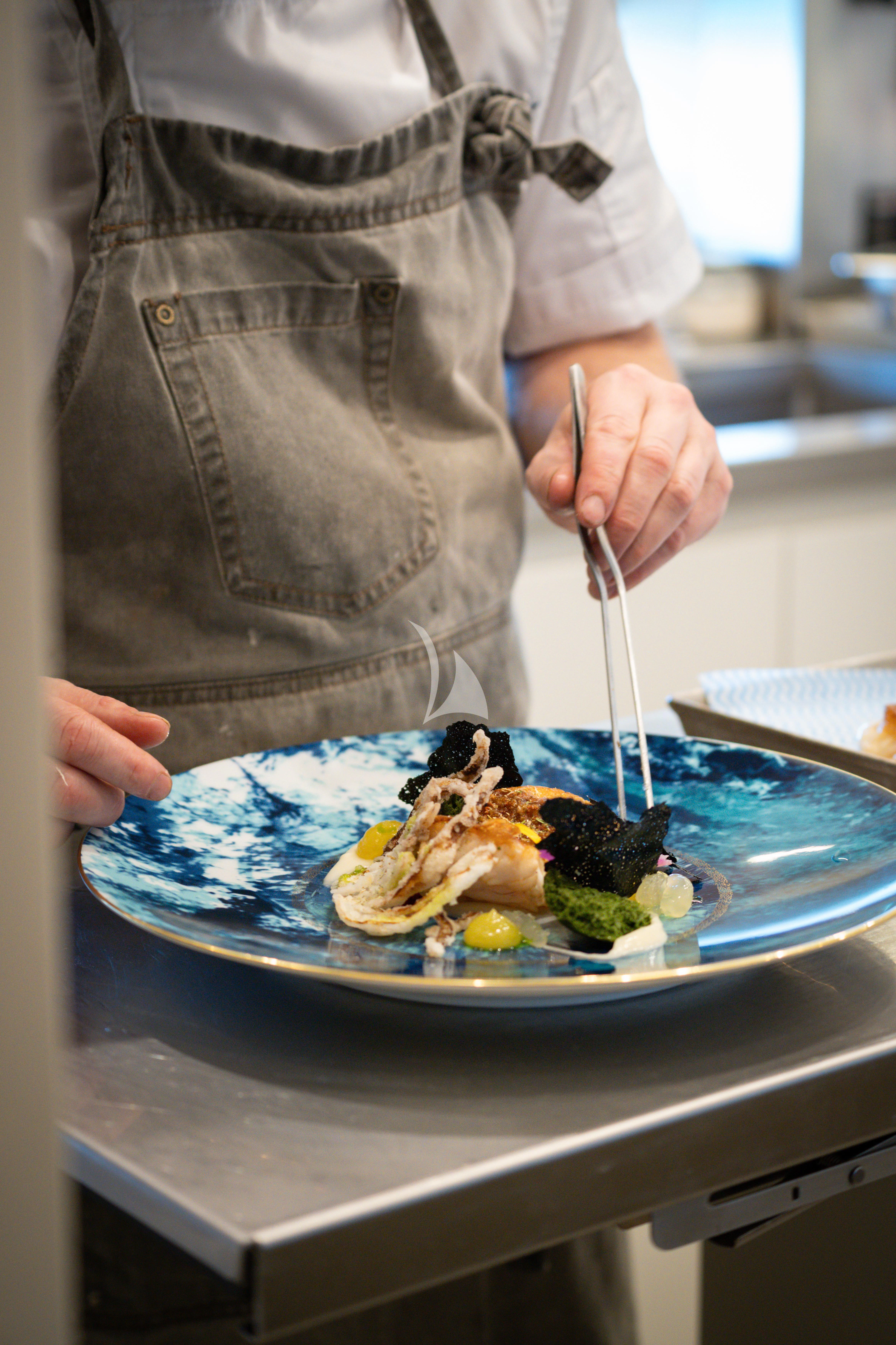 a woman eating food aboard AIX Yacht for Sale