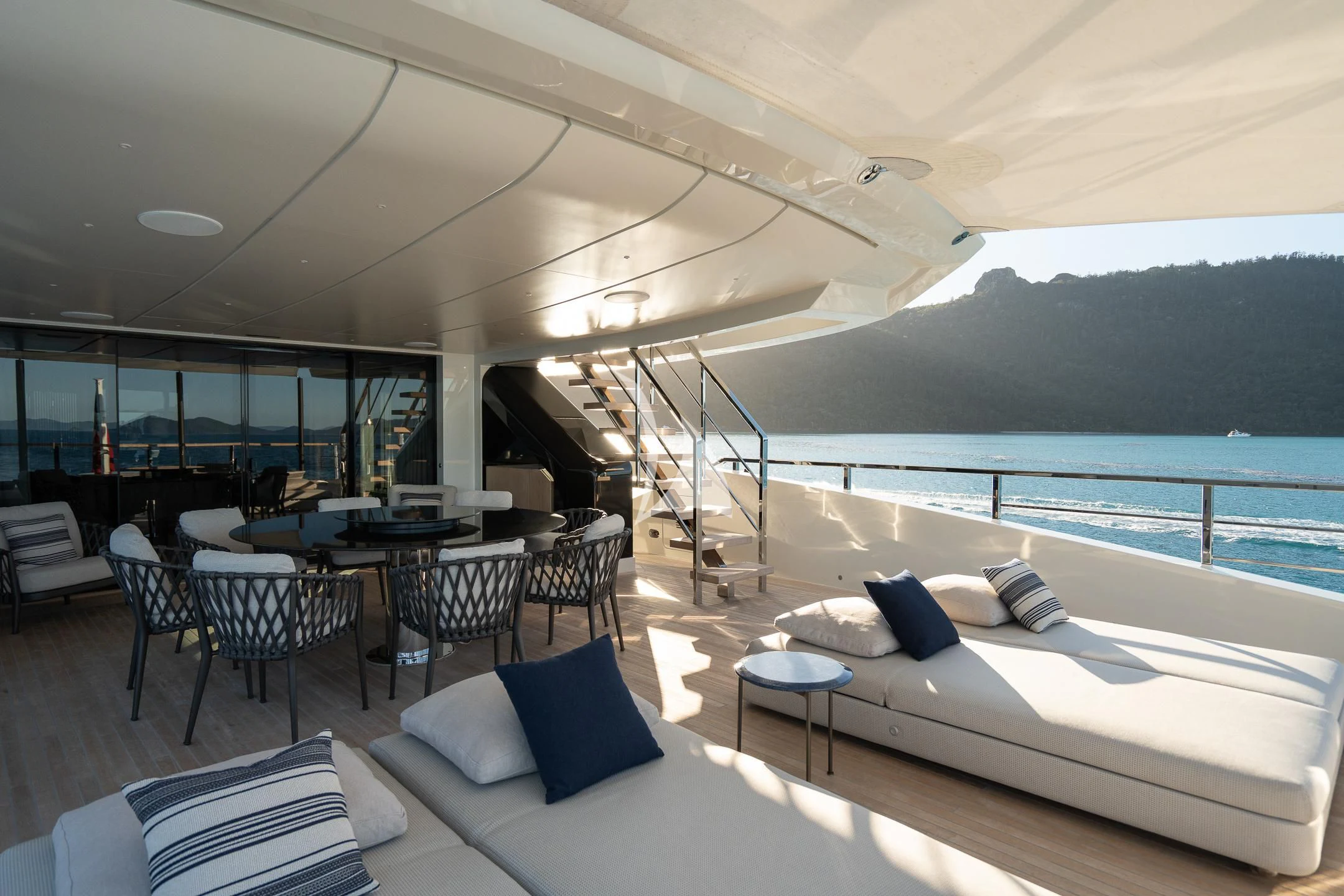 a room with a bed and a table and chairs aboard AIX Yacht for Sale