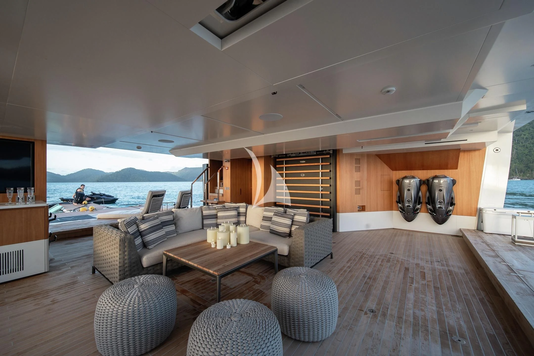 a living room with a large wood floor and a large body of water aboard AIX Yacht for Sale