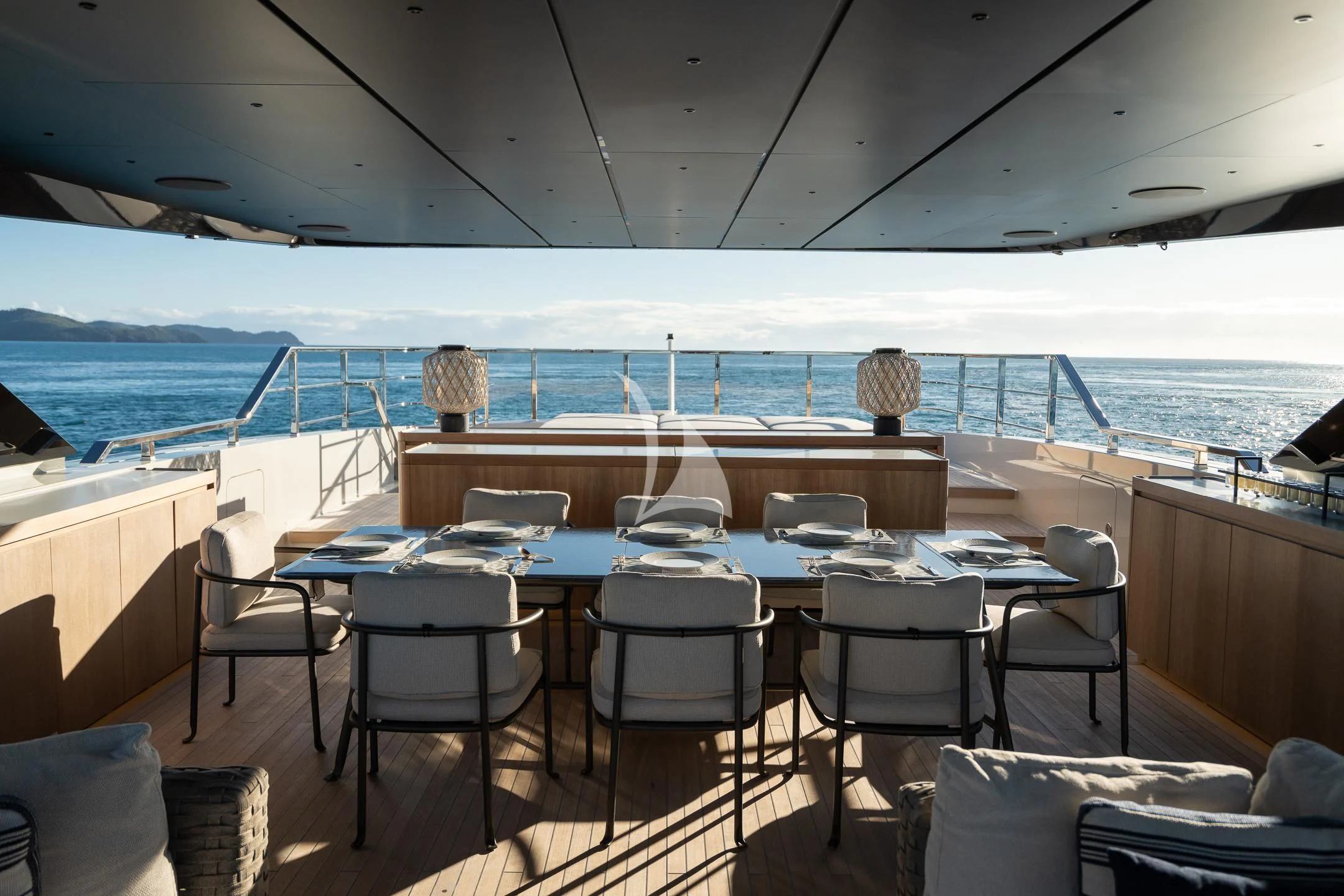 a table and chairs on a deck aboard AIX Yacht for Sale