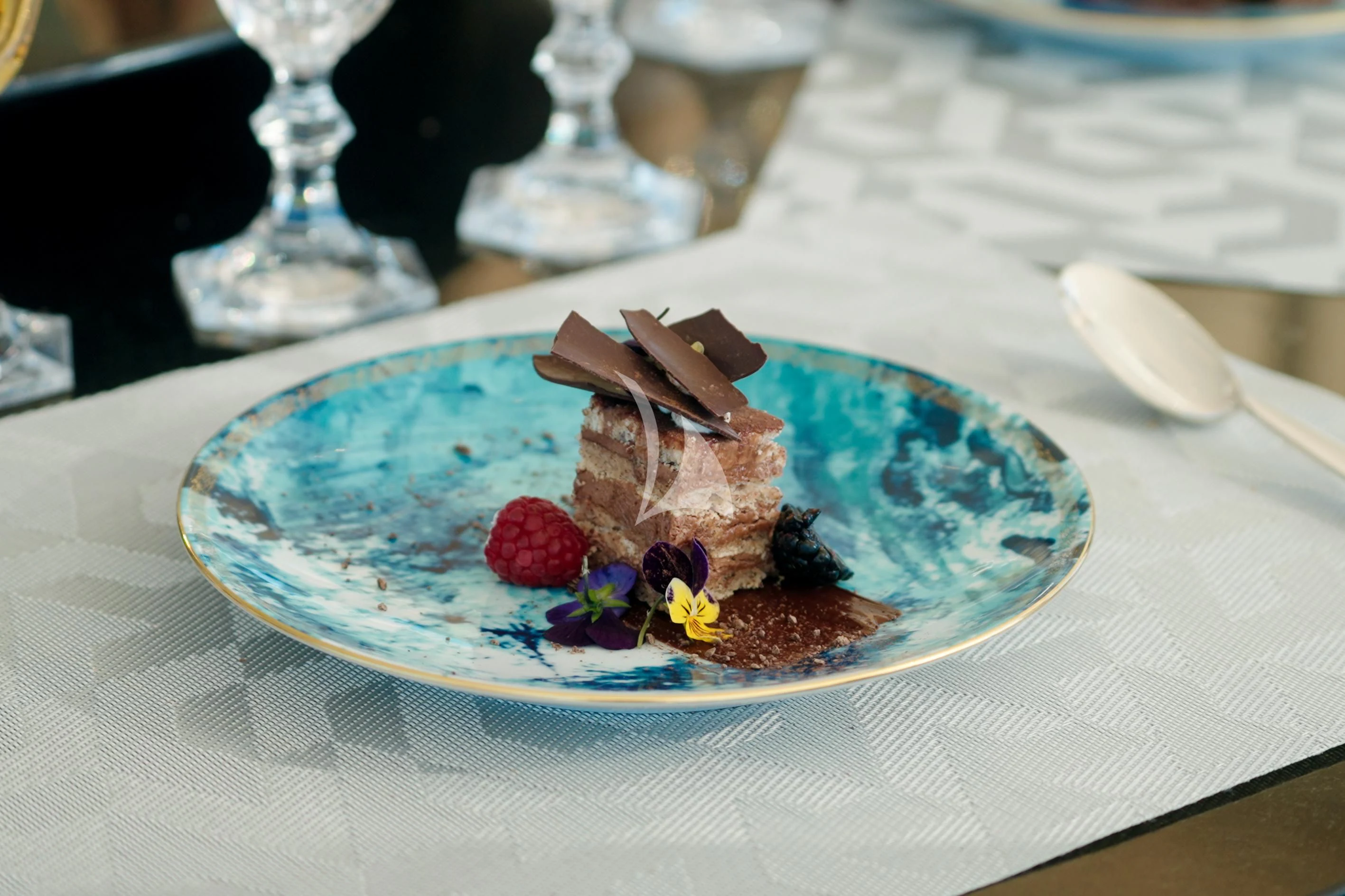 a piece of cake on a plate aboard AIX Yacht for Sale
