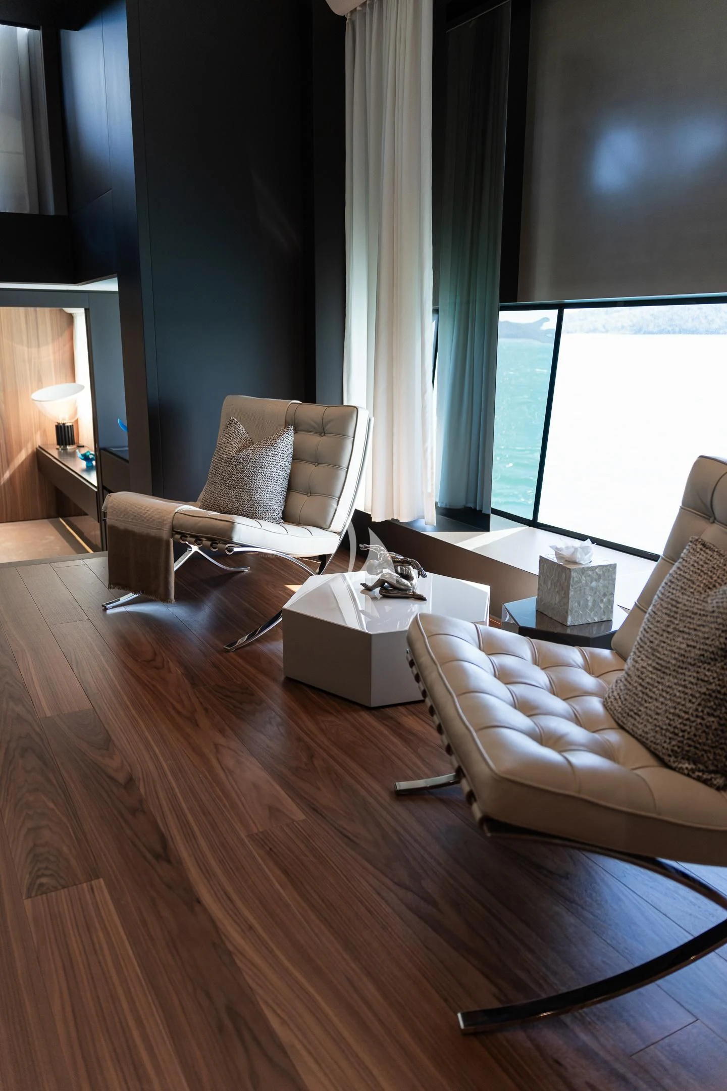 a living room with a wood floor aboard AIX Yacht for Sale