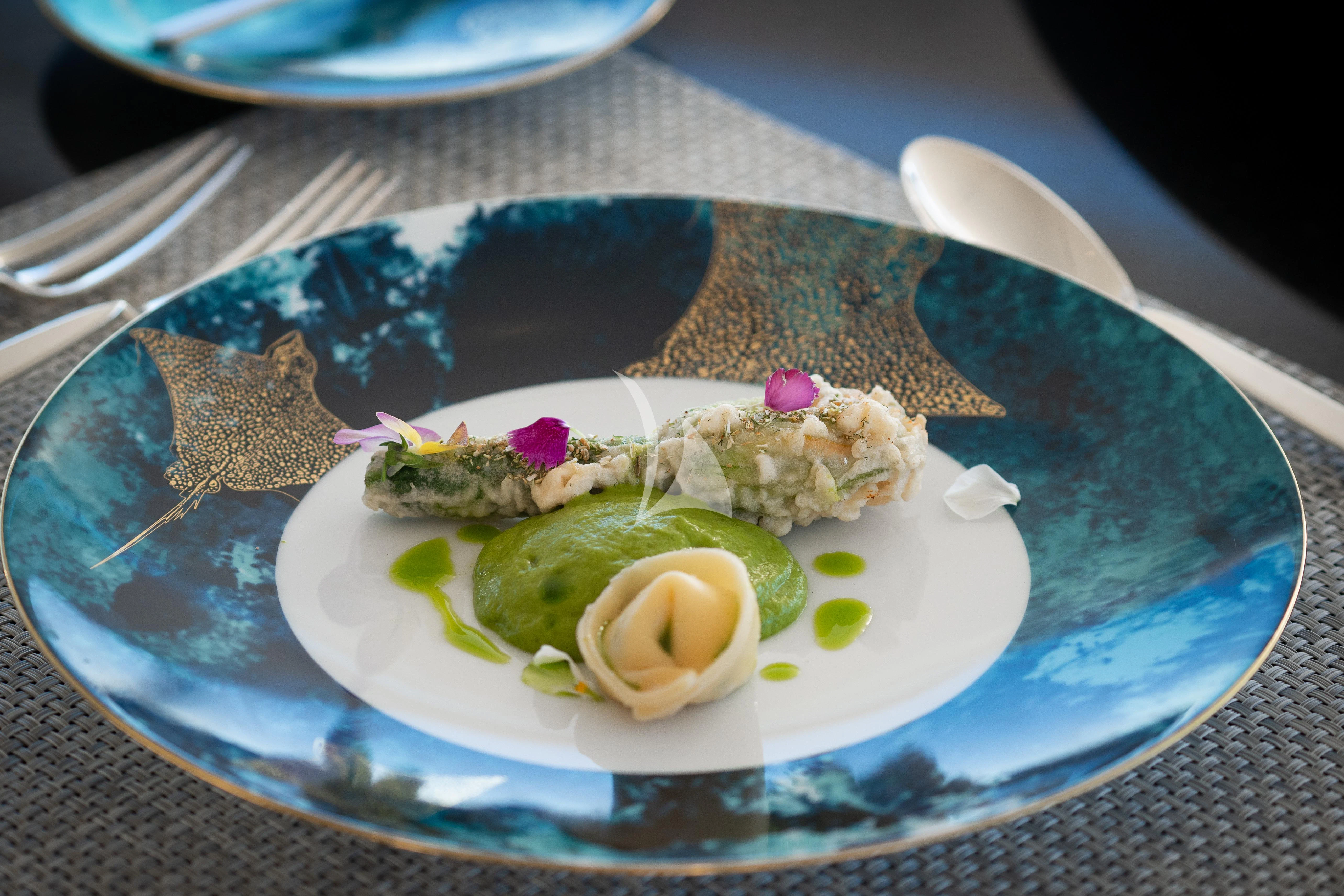 a plate of food aboard AIX Yacht for Sale