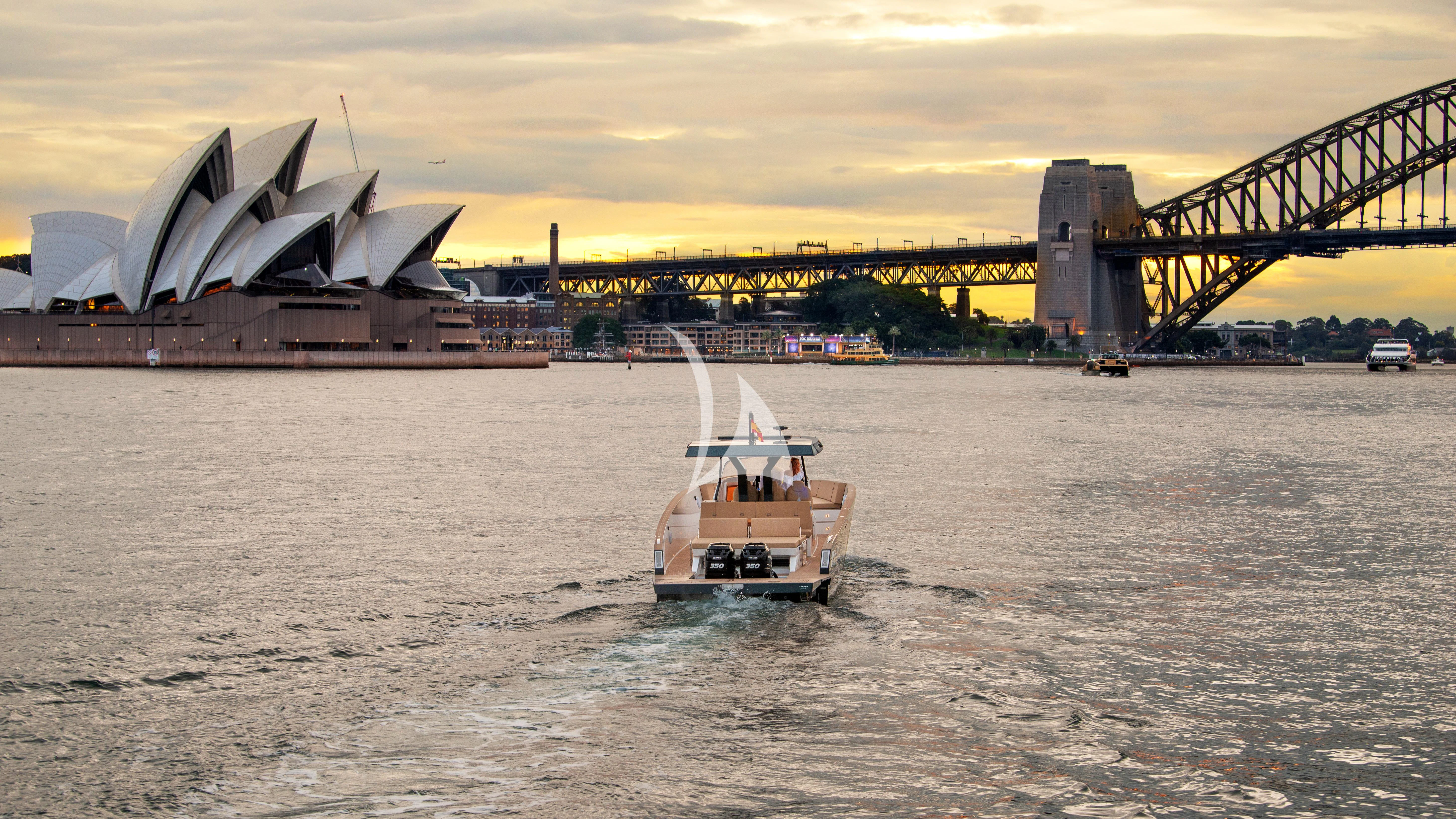 a boat sailing under a bridge aboard AIX Yacht for Sale