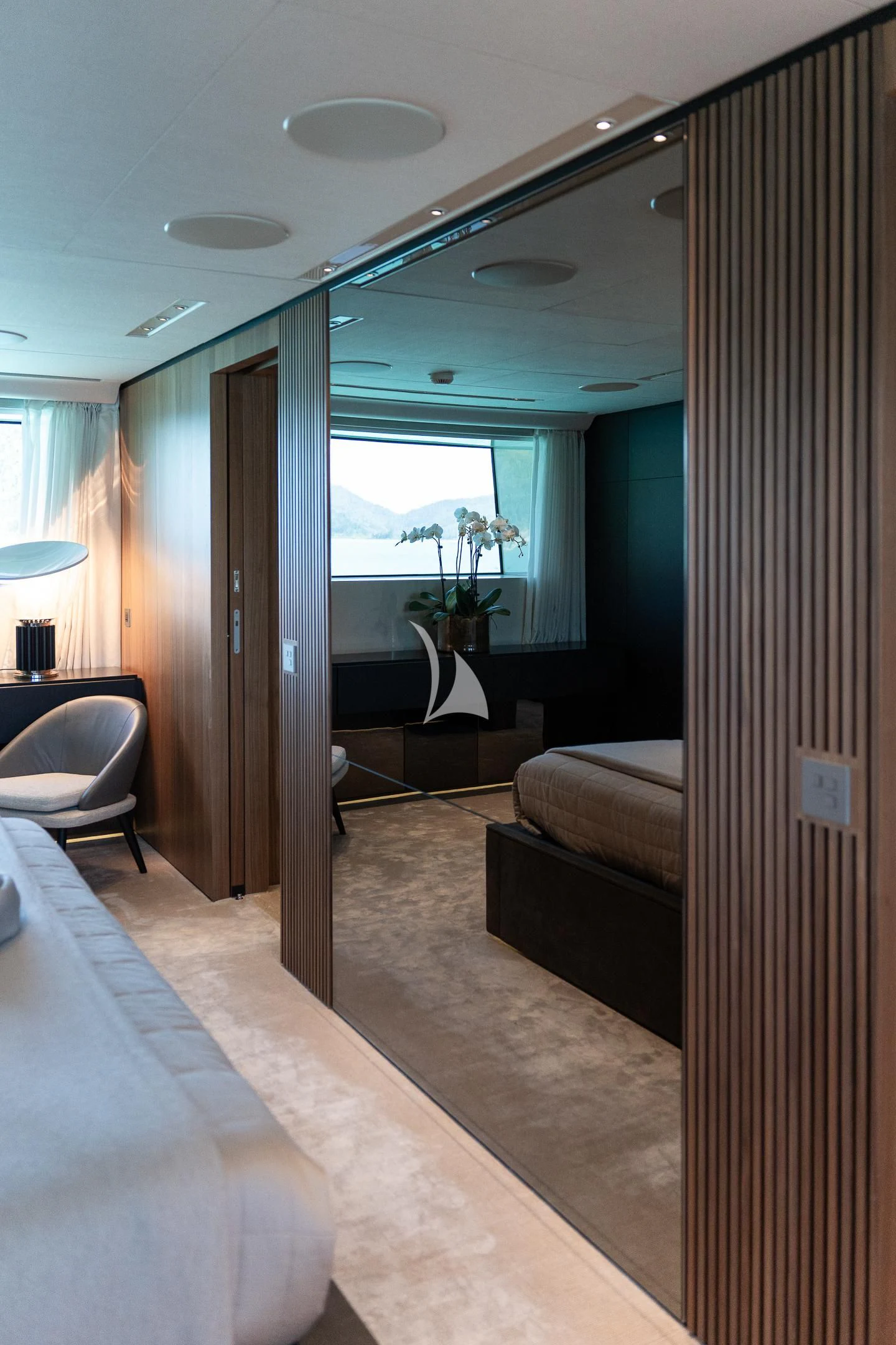 a room with a bed and a chair aboard AIX Yacht for Sale