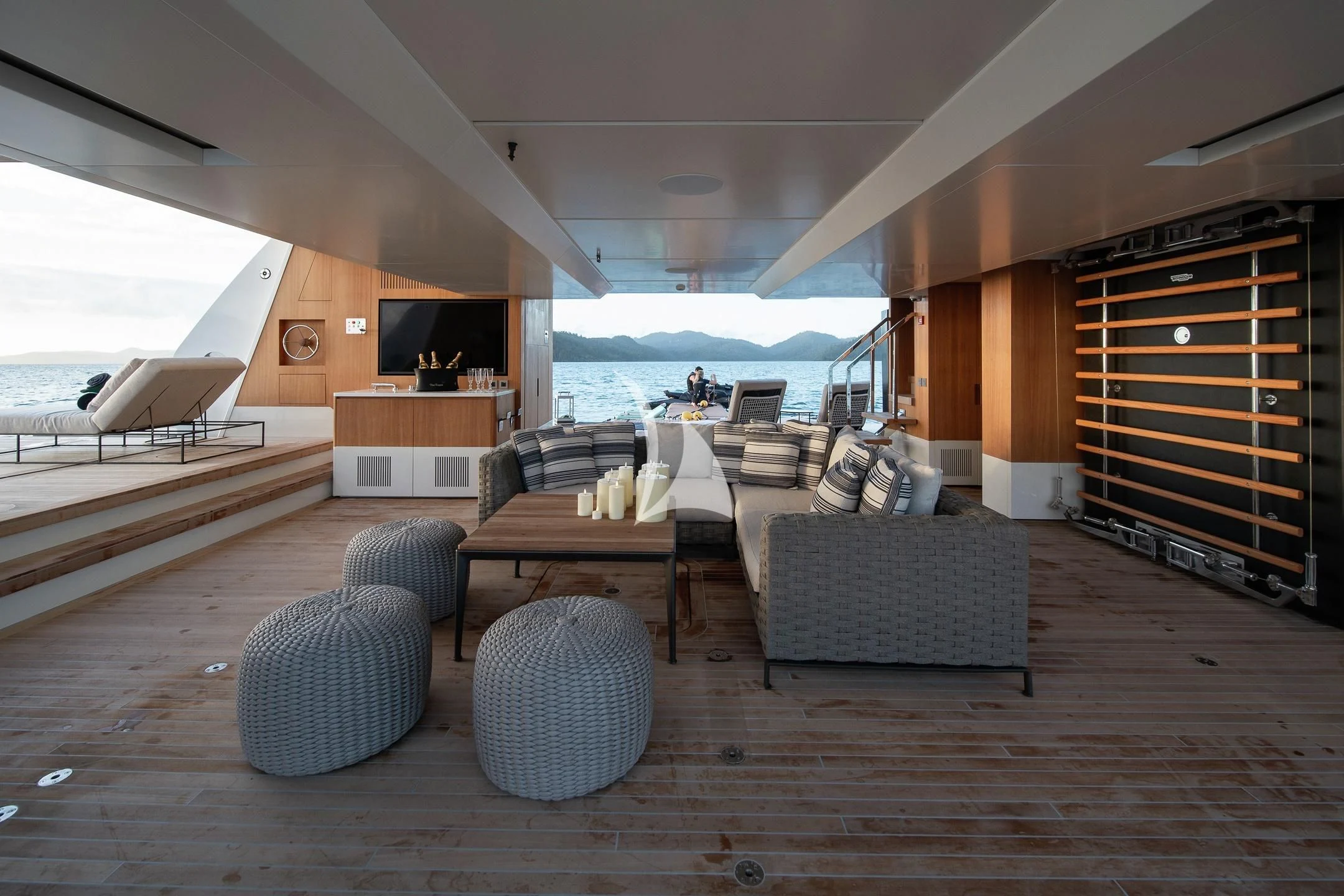 a living room with a wood table aboard AIX Yacht for Sale