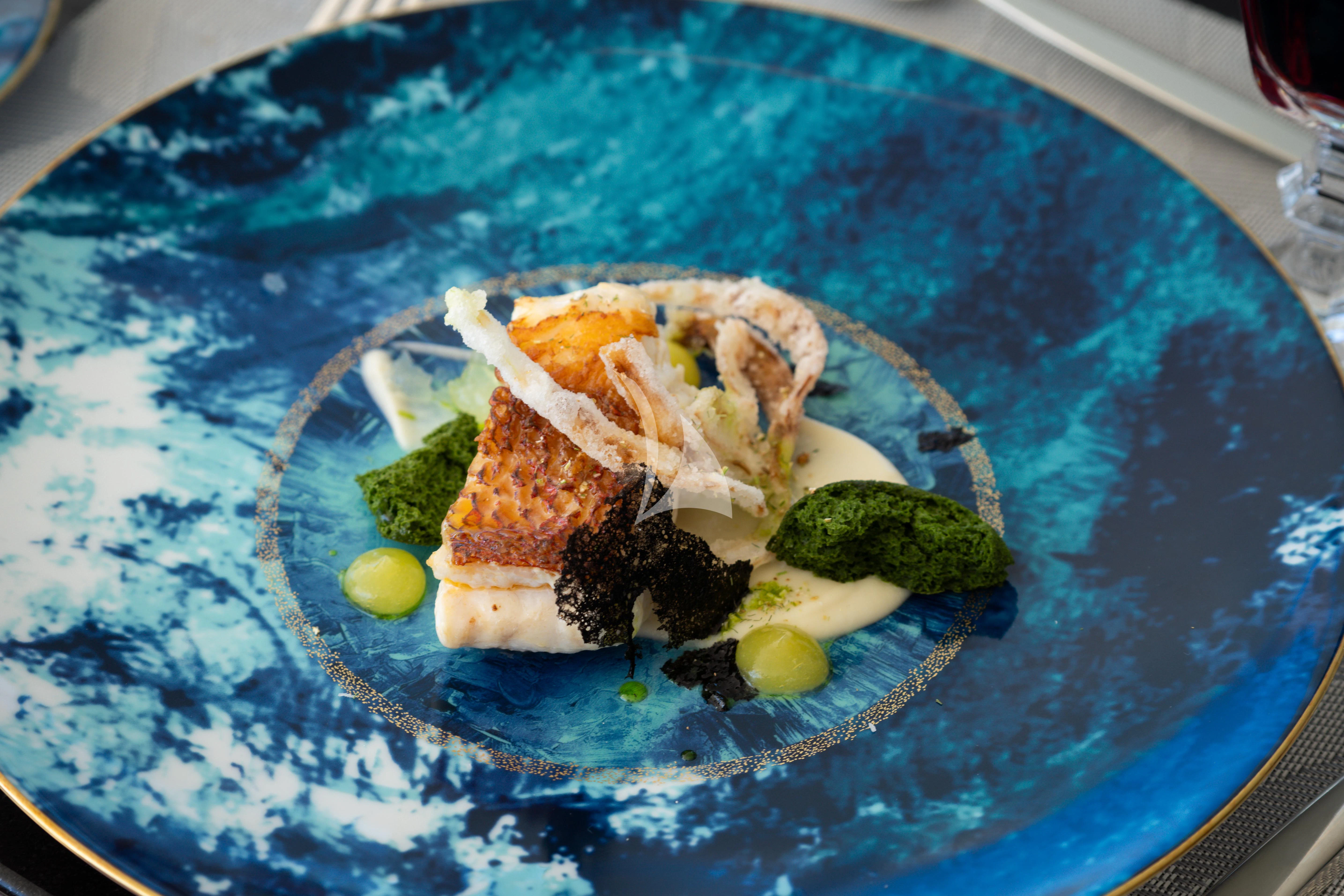 a plate of food aboard AIX Yacht for Sale