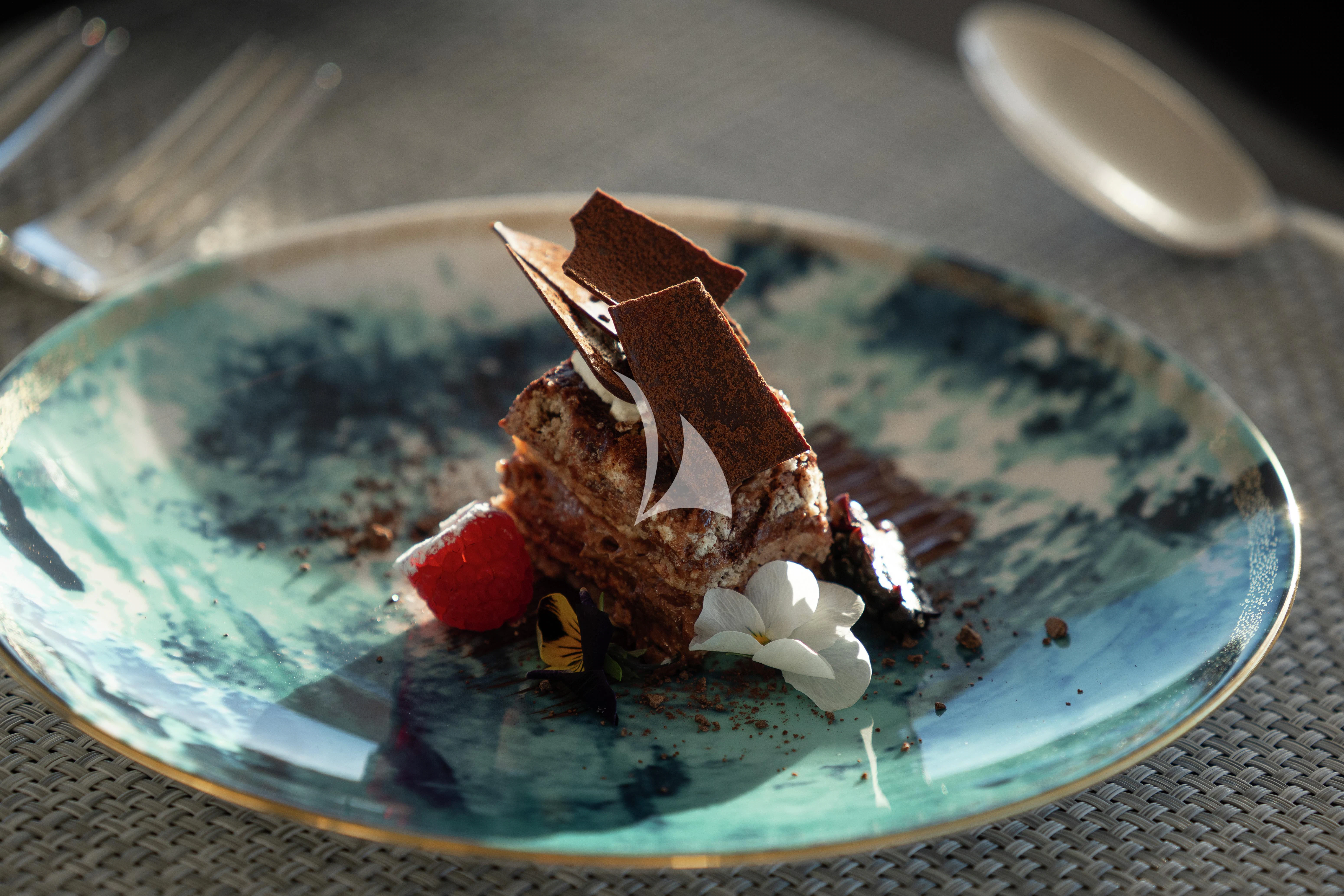 a piece of cake on a plate aboard AIX Yacht for Sale