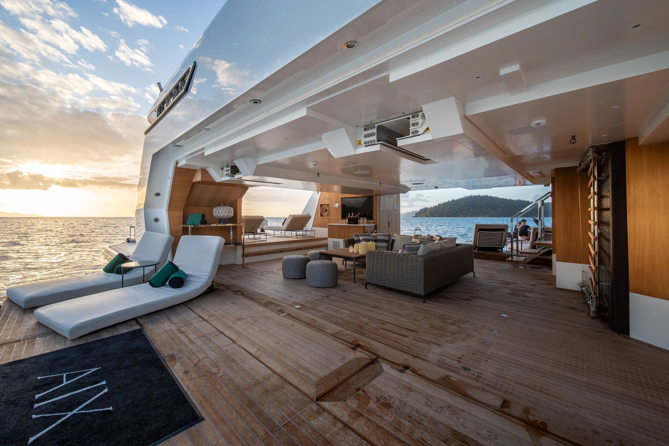 a large open living room with a large deck and a large pool aboard AIX Yacht for Sale