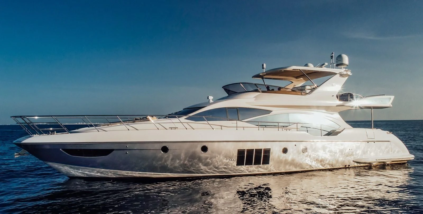 a white yacht on a beach aboard AZIMUT 85 Yacht for Sale