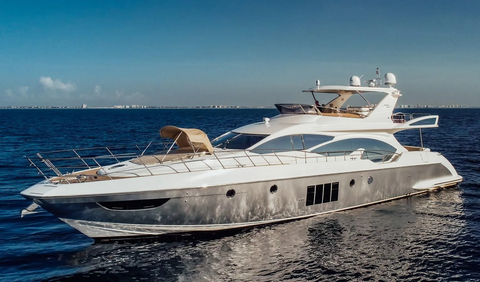 a white yacht on a beach aboard AZIMUT 85 Yacht for Sale