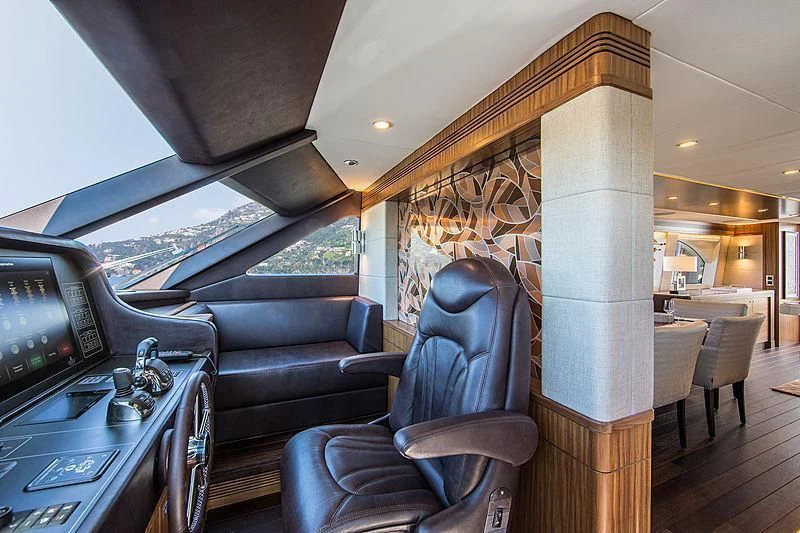 a living room with a leather couch aboard JOY Yacht for Sale