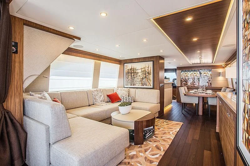 a living room with a couch and a table aboard JOY Yacht for Sale