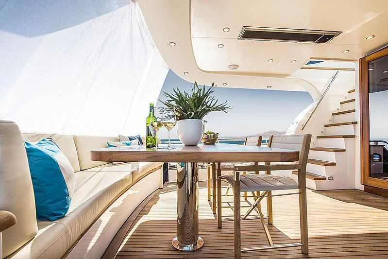 a table and chairs in a room aboard JOY Yacht for Sale