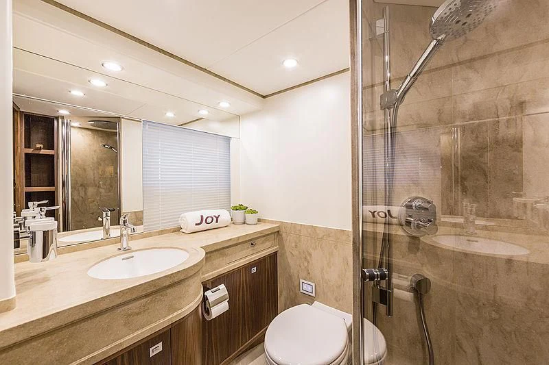 a bathroom with a glass shower aboard JOY Yacht for Sale