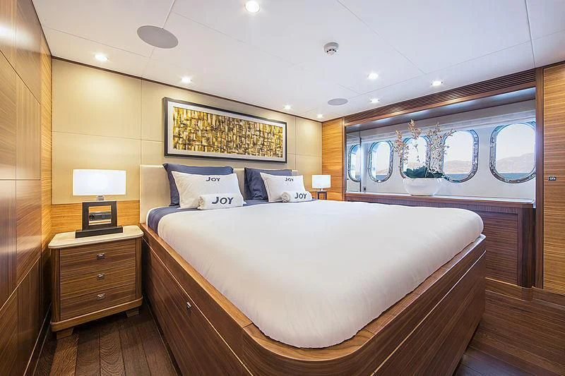 a large bed in a room aboard JOY Yacht for Sale