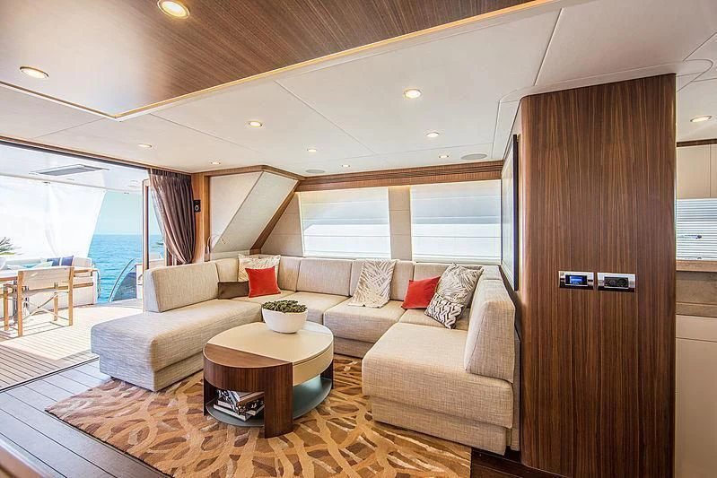 a living room with a couch and a table aboard JOY Yacht for Sale
