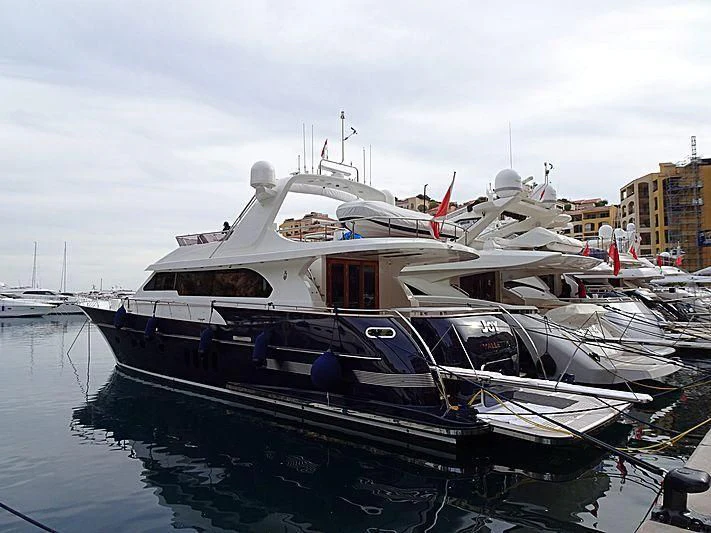 a boat docked in a harbor aboard JOY Yacht for Sale