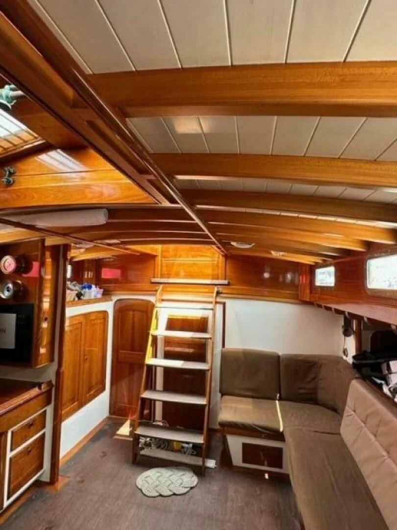 a living room with a wood cabinet aboard WILD HORSES Yacht for Sale