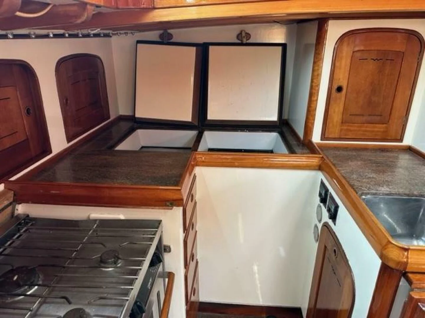 a kitchen with a stove and cabinets aboard WILD HORSES Yacht for Sale