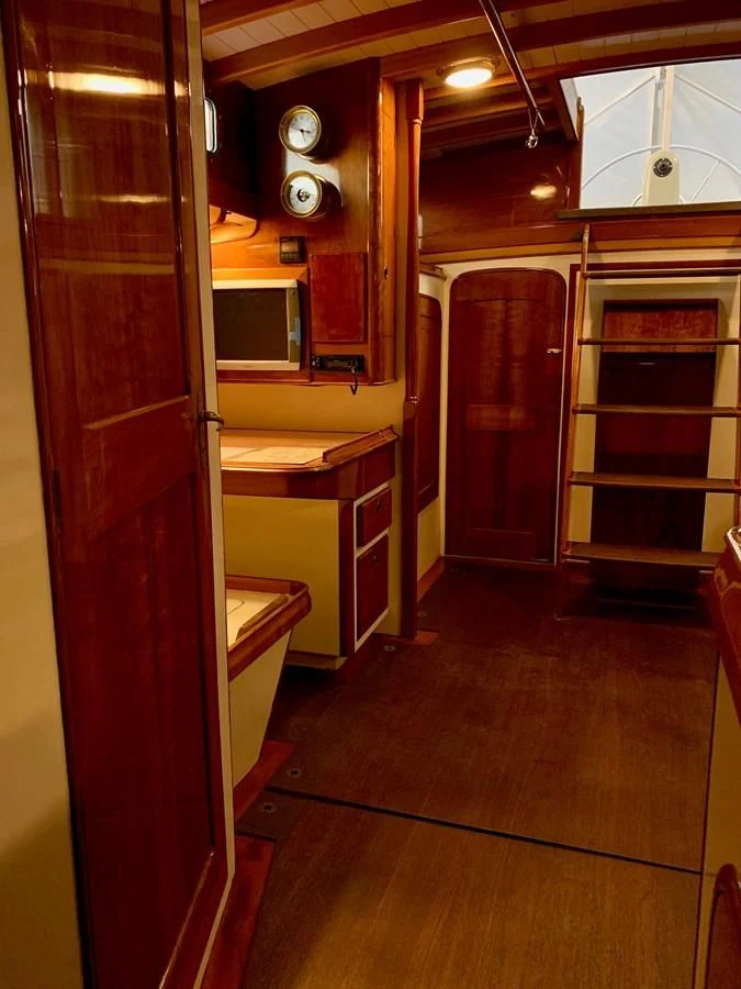 a kitchen with wooden cabinets aboard WILD HORSES Yacht for Sale