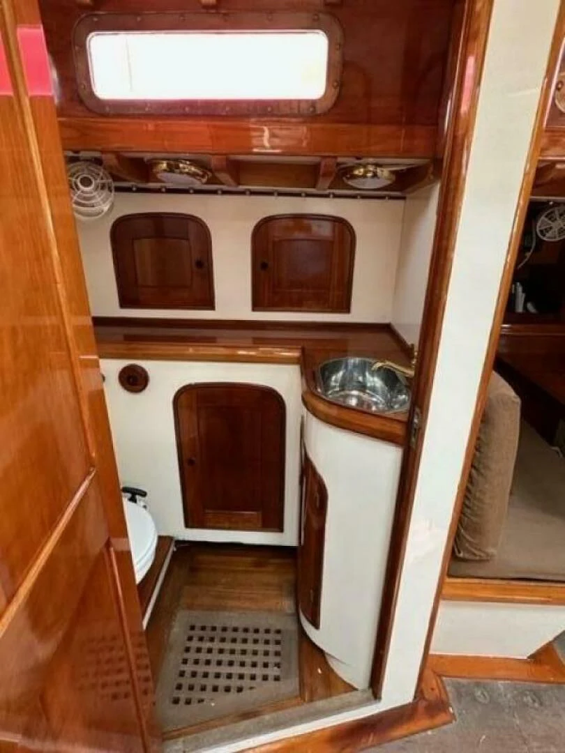 a small kitchen with a small refrigerator aboard WILD HORSES Yacht for Sale