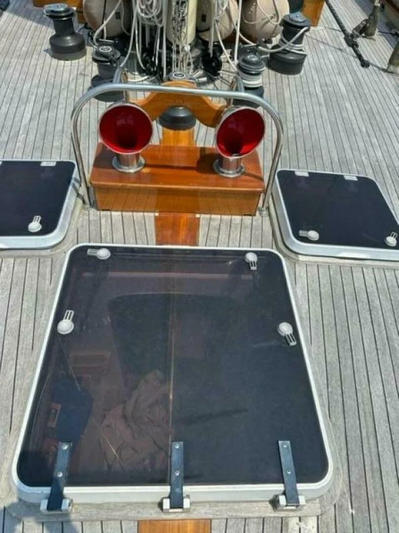 a rectangular electronic device with a glass of red liquid and a small black device on a table with aboard WILD HORSES Yacht for Sale