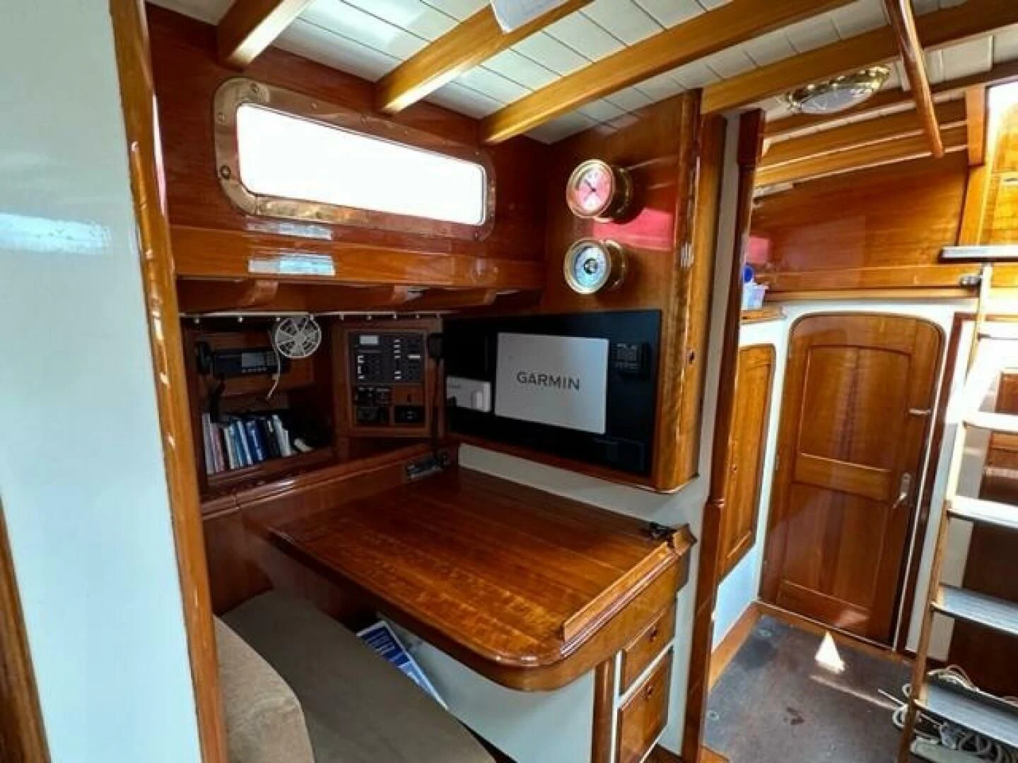 a room with a wood table and a tv aboard WILD HORSES Yacht for Sale
