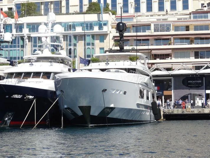 a couple of boats sit in a harbor aboard UNICORN Yacht for Sale
