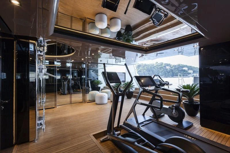 a room with a large window and a table with chairs and a large window with a view of aboard UNICORN Yacht for Sale