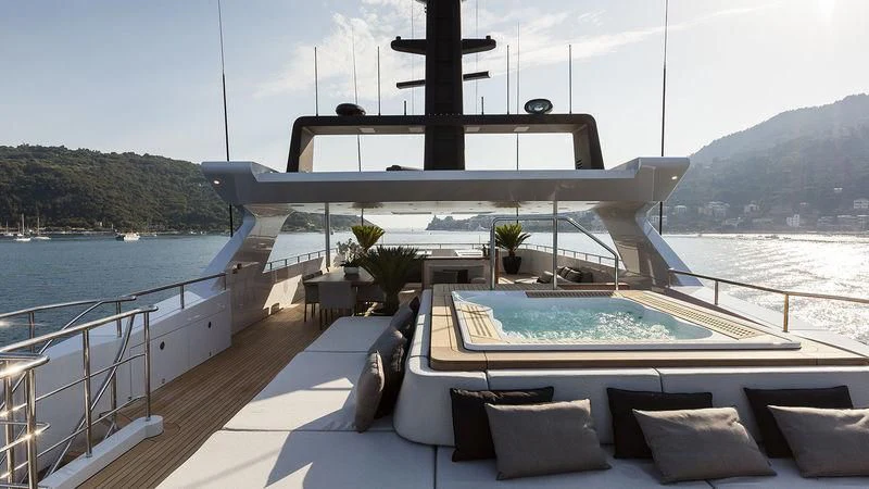 a large pool with a deck overlooking a large body of water aboard UNICORN Yacht for Sale