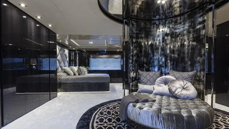 a room with a bed and a large window aboard UNICORN Yacht for Sale