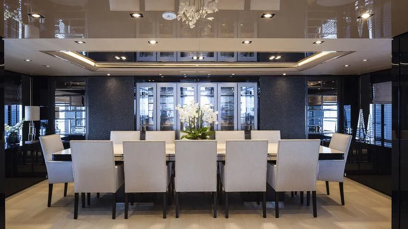 a room with chairs and tables aboard UNICORN Yacht for Sale