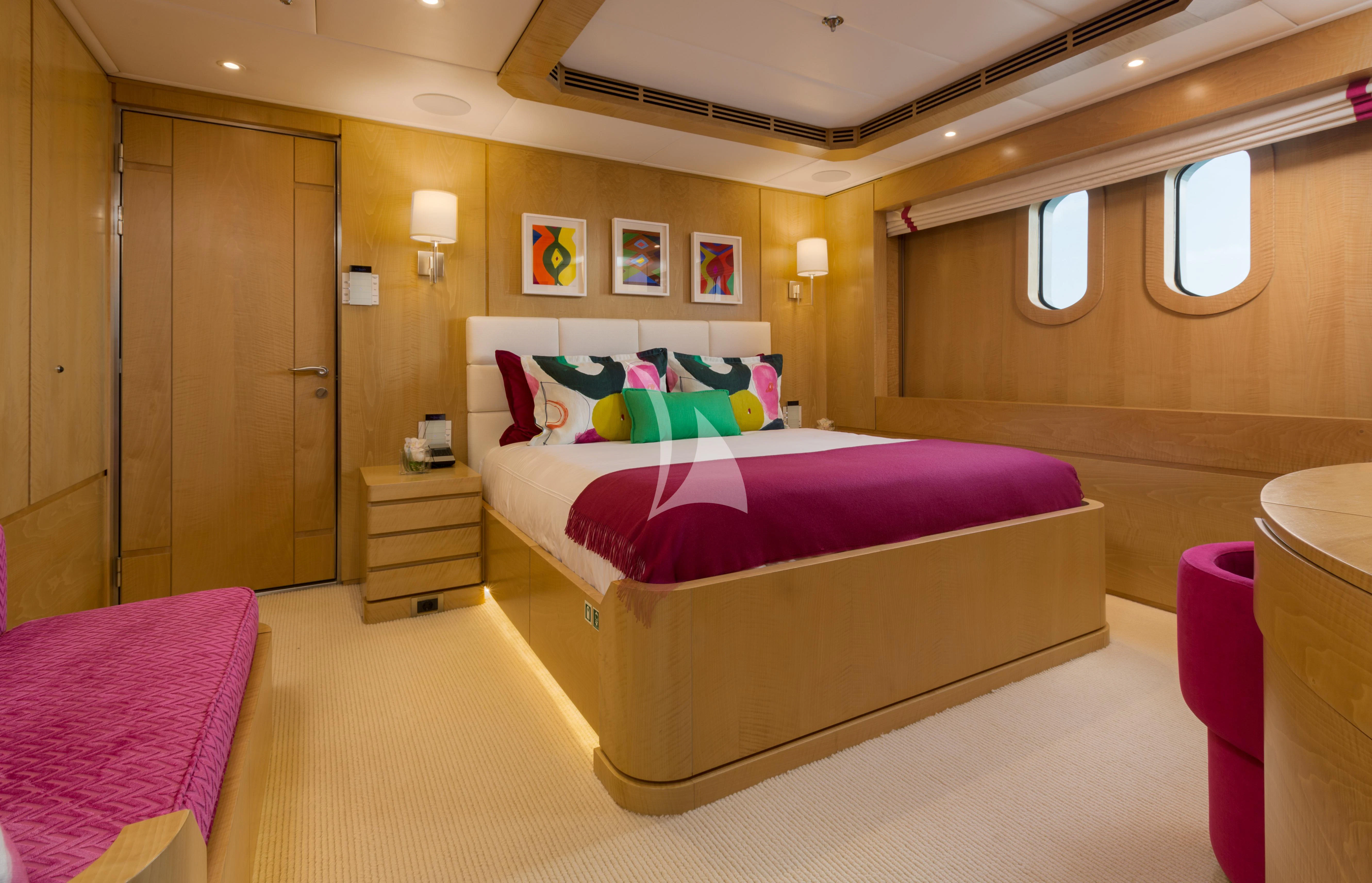 a room with a bed and a closet aboard BACA Yacht for Charter