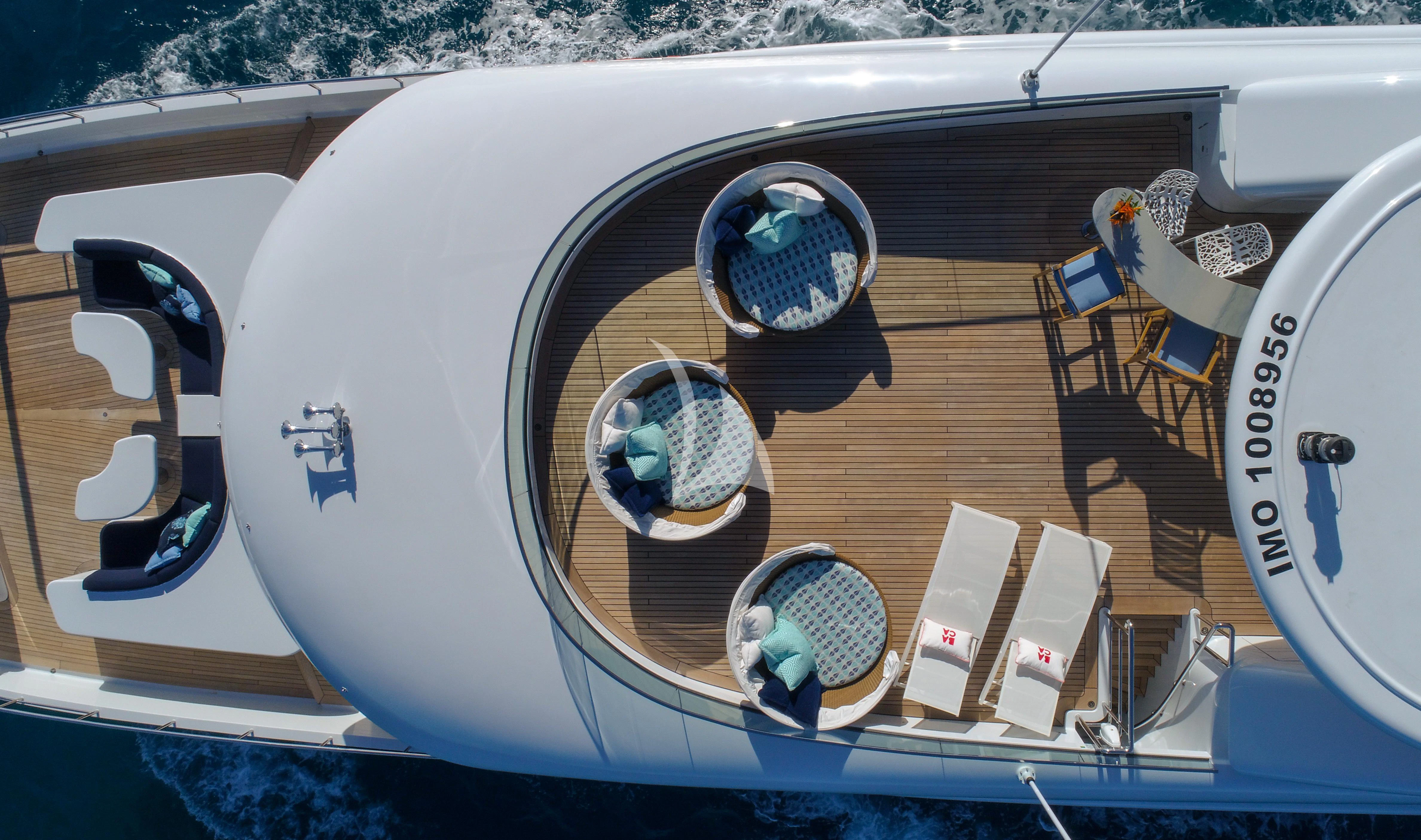 a white boat with a dock and a dock aboard BACA Yacht for Charter
