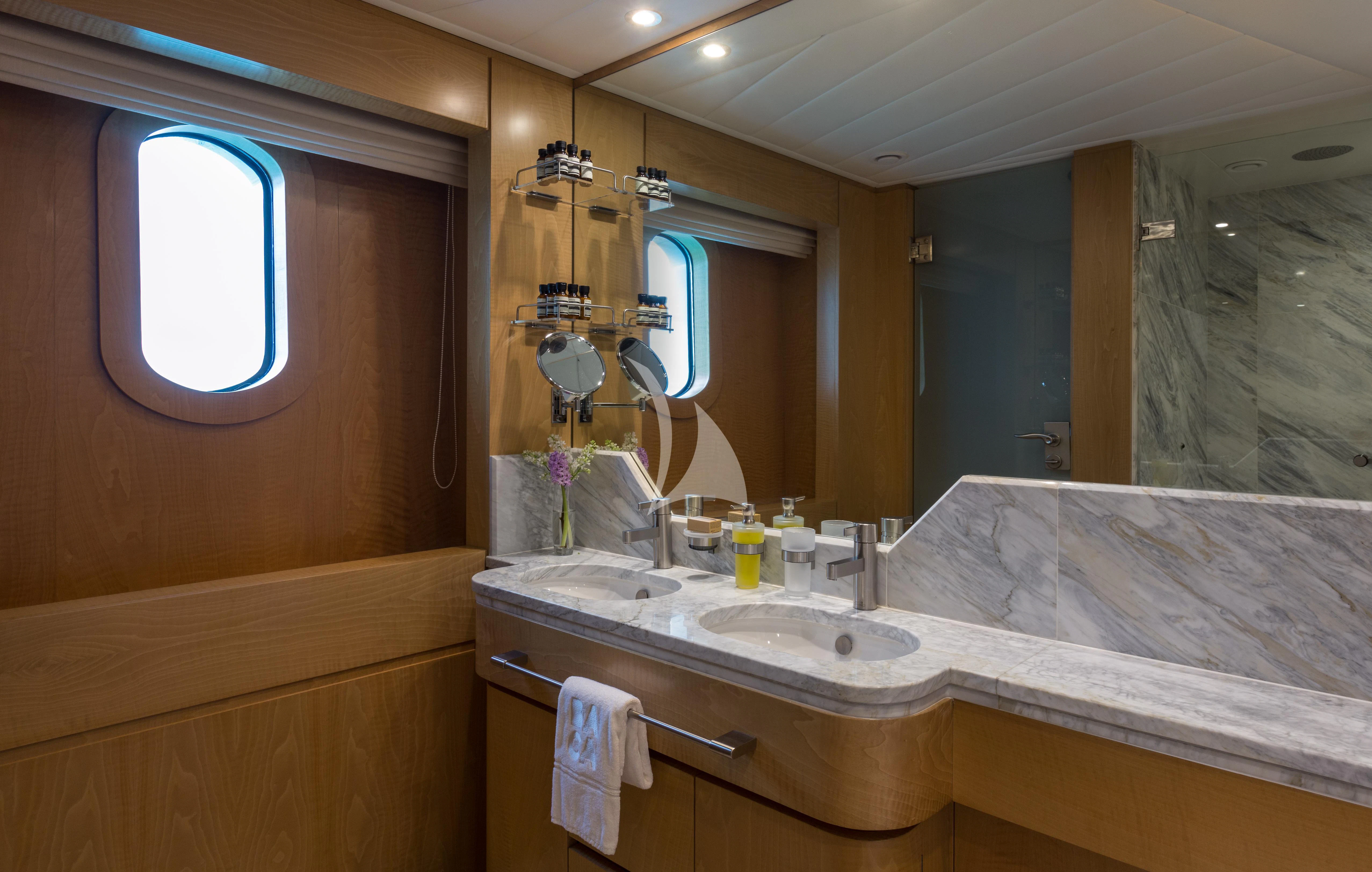 a bathroom with a sink and a mirror aboard BACA Yacht for Charter