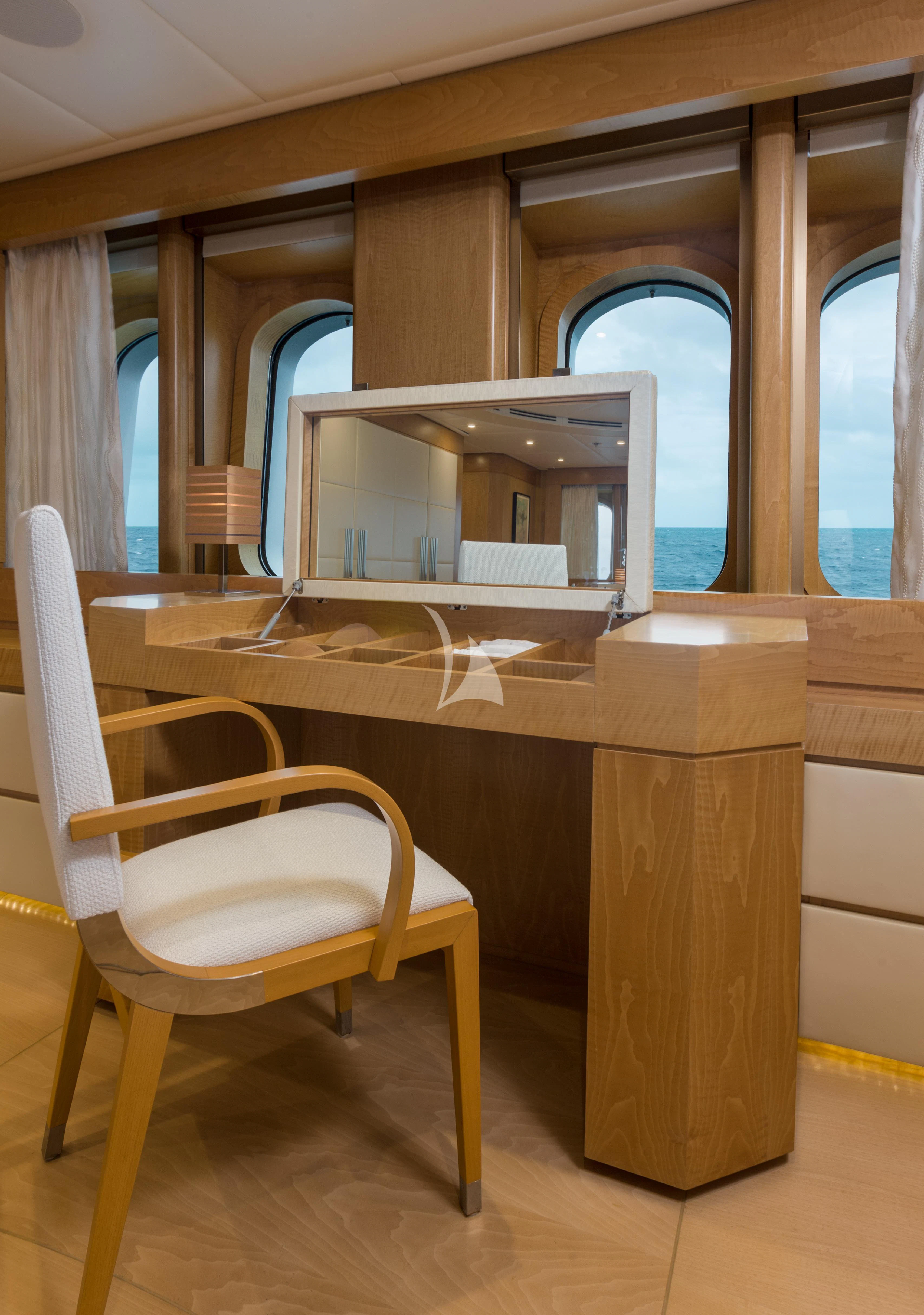 a room with a desk and chairs aboard BACA Yacht for Charter
