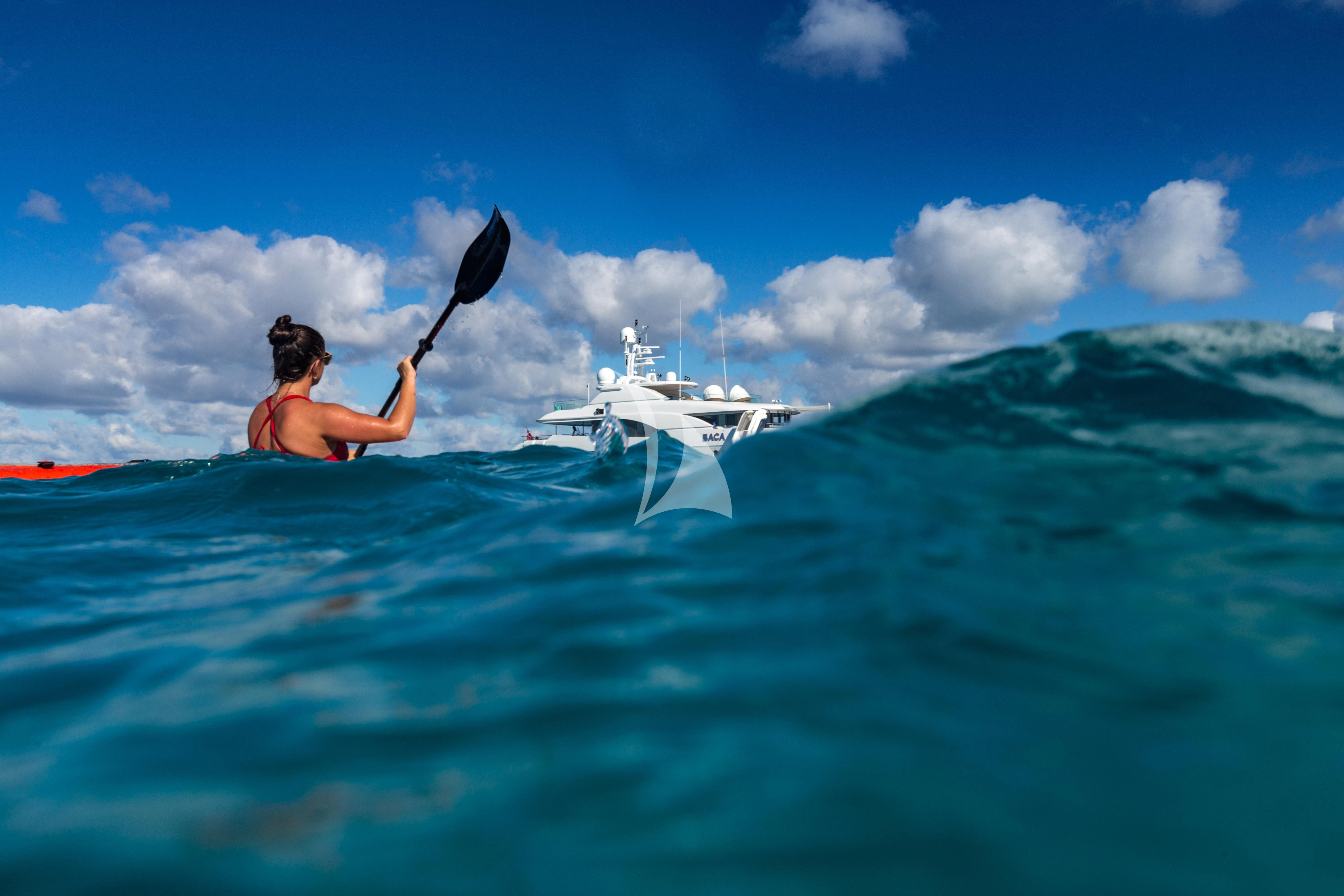 a man on a surfboard in the ocean aboard BACA Yacht for Charter