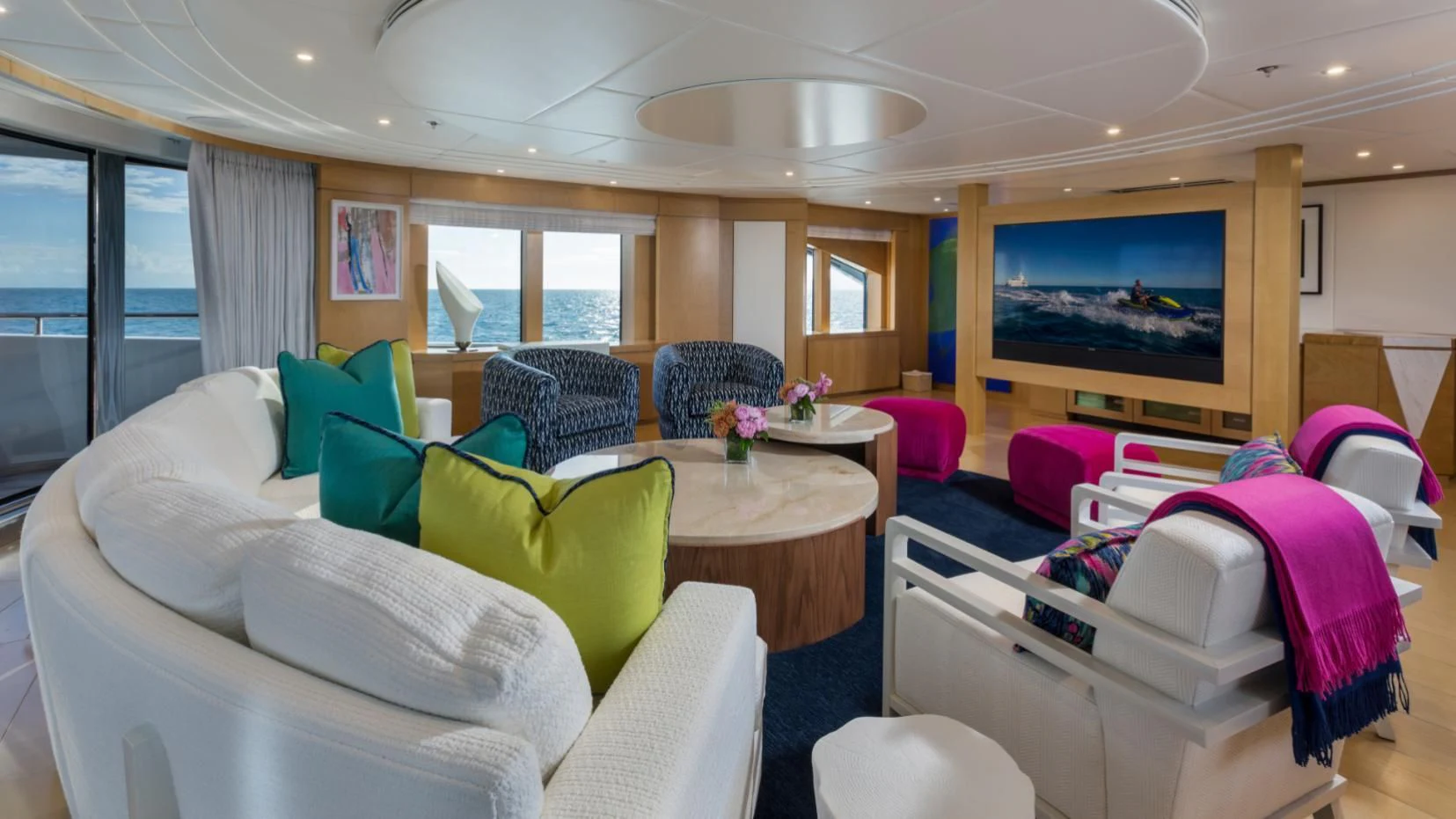 a living room with a tv and furniture aboard BACA Yacht for Charter
