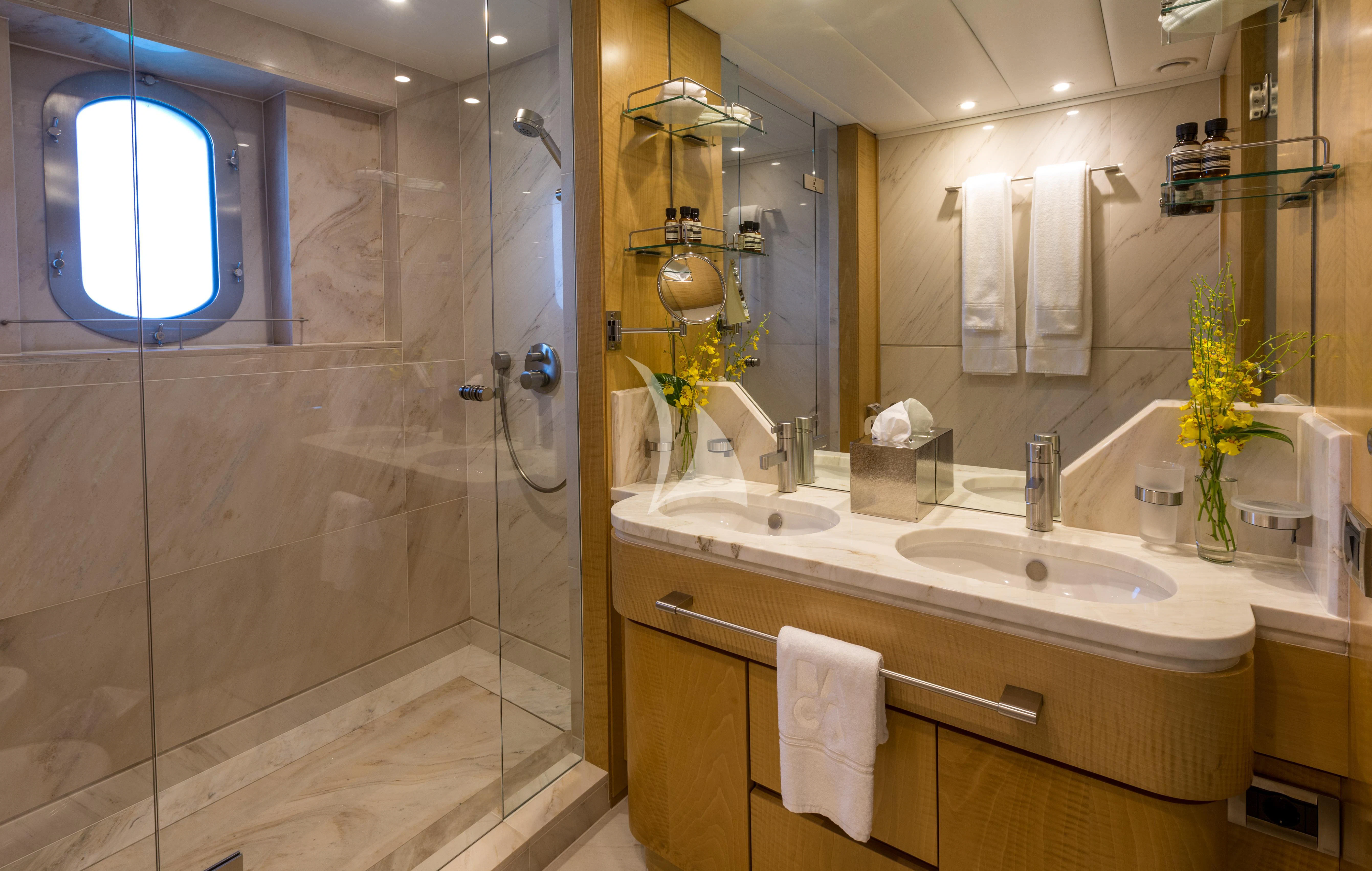 a bathroom with a glass shower aboard BACA Yacht for Charter