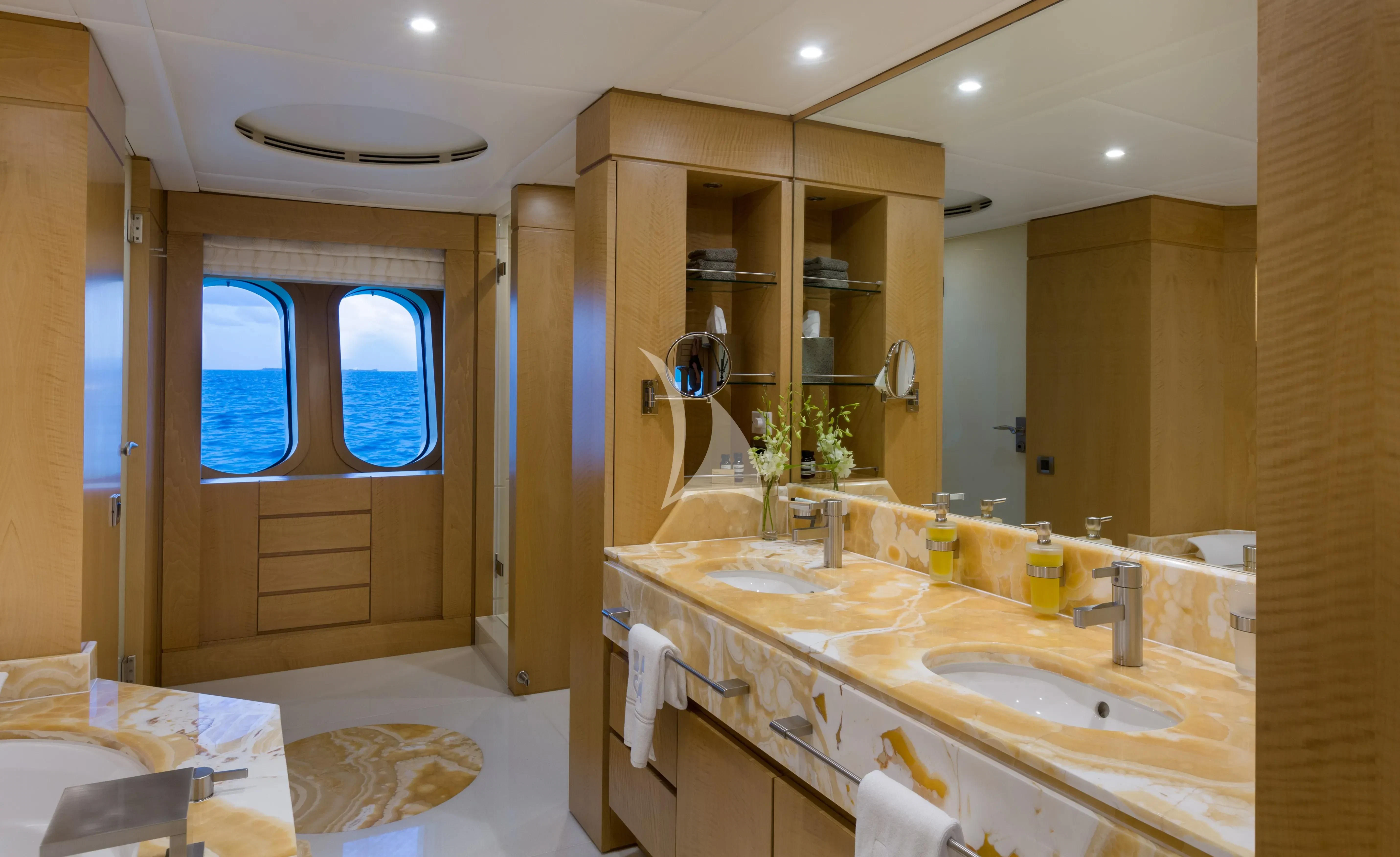 a bathroom with a large mirror aboard BACA Yacht for Charter