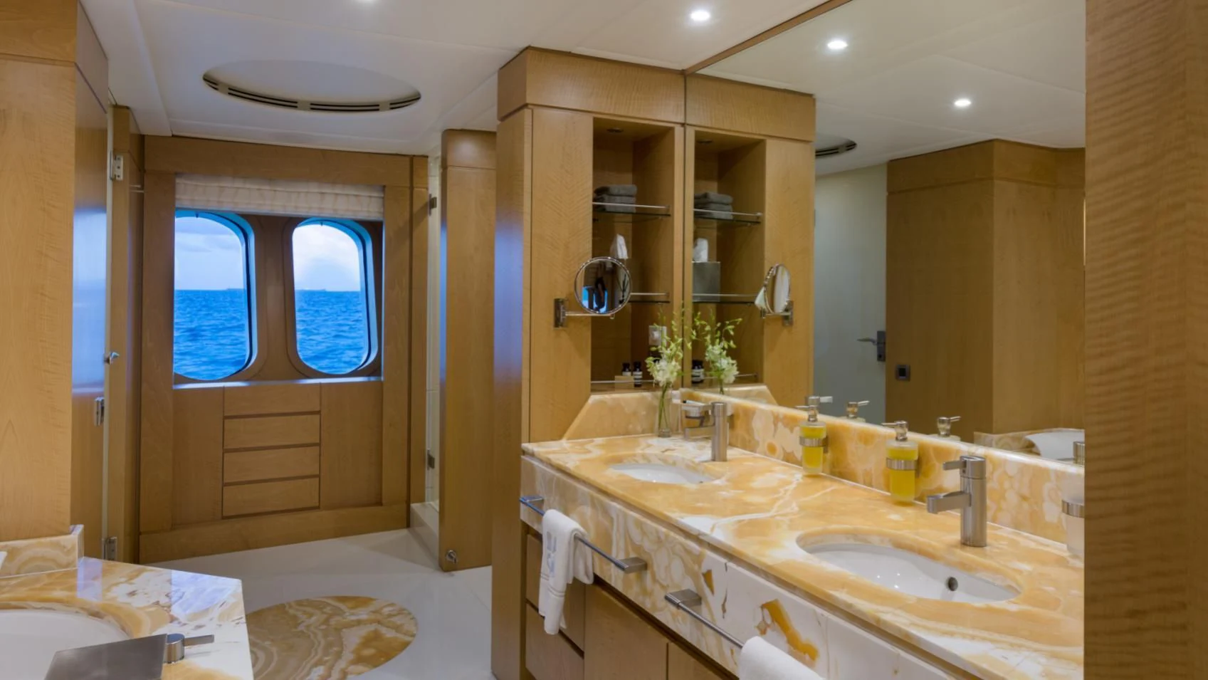 a bathroom with a sink and a mirror aboard BACA Yacht for Charter