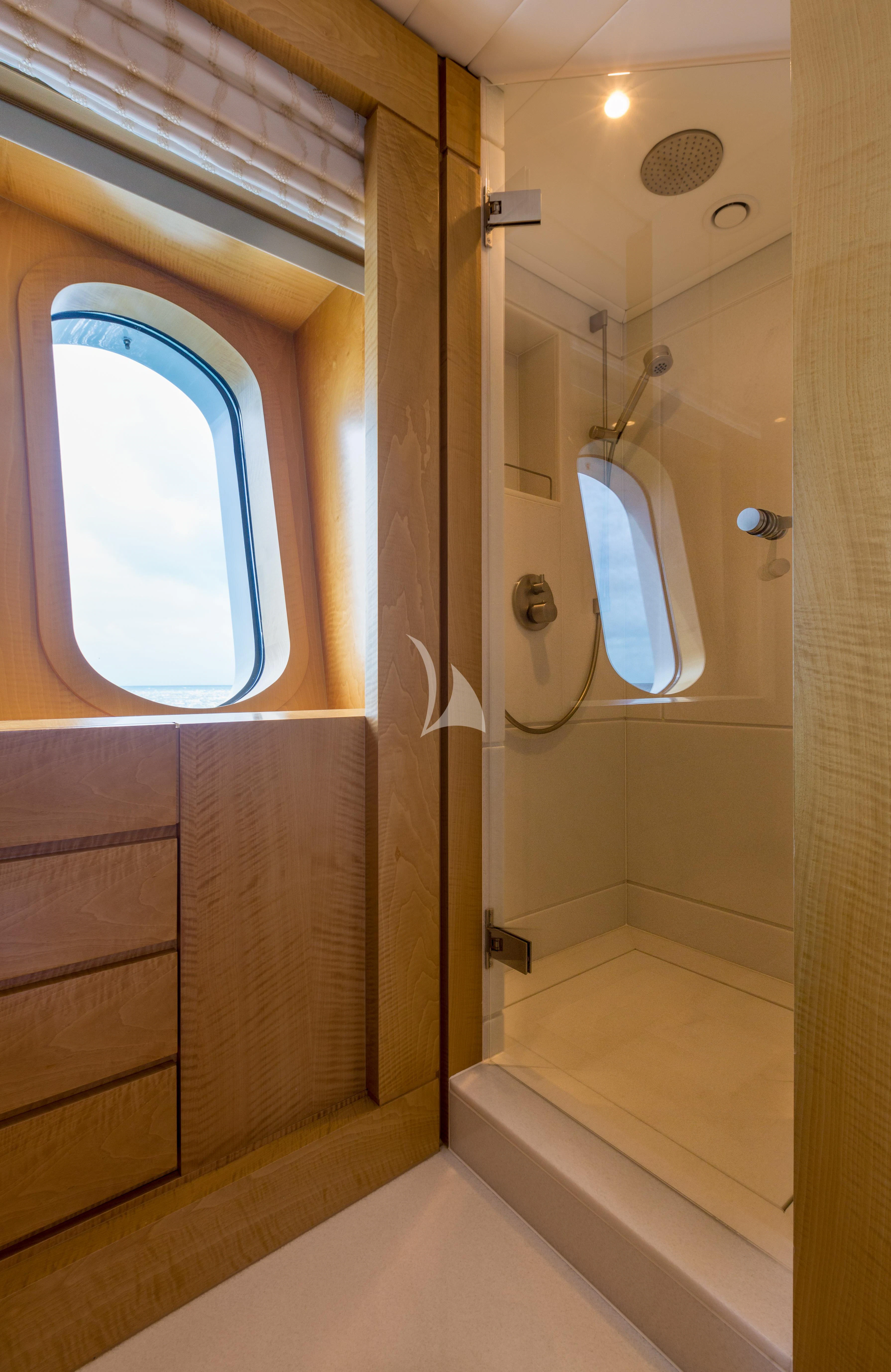 a bathroom with a shower and a window aboard BACA Yacht for Charter