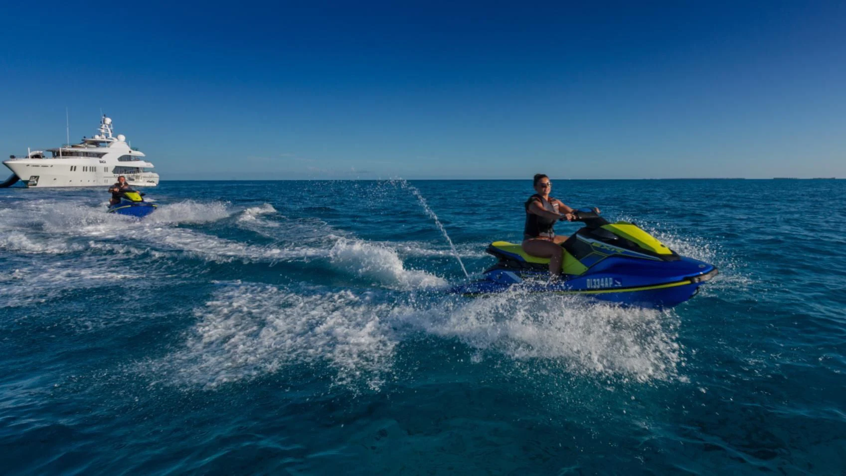 a man riding a surfboard in the ocean aboard BACA Yacht for Charter